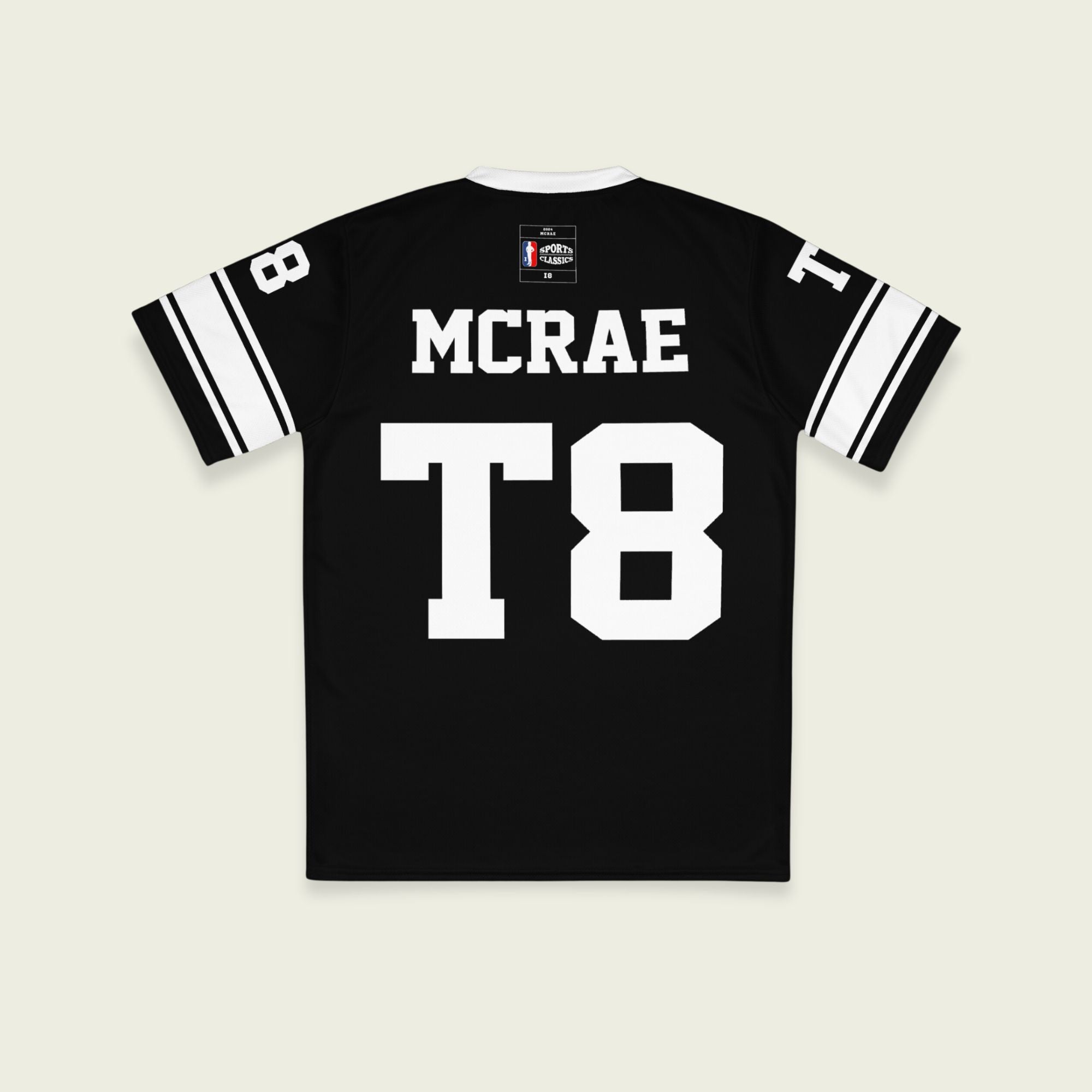 A black and white football jersey with Tate Mcare on the back and front in white with a white outline.