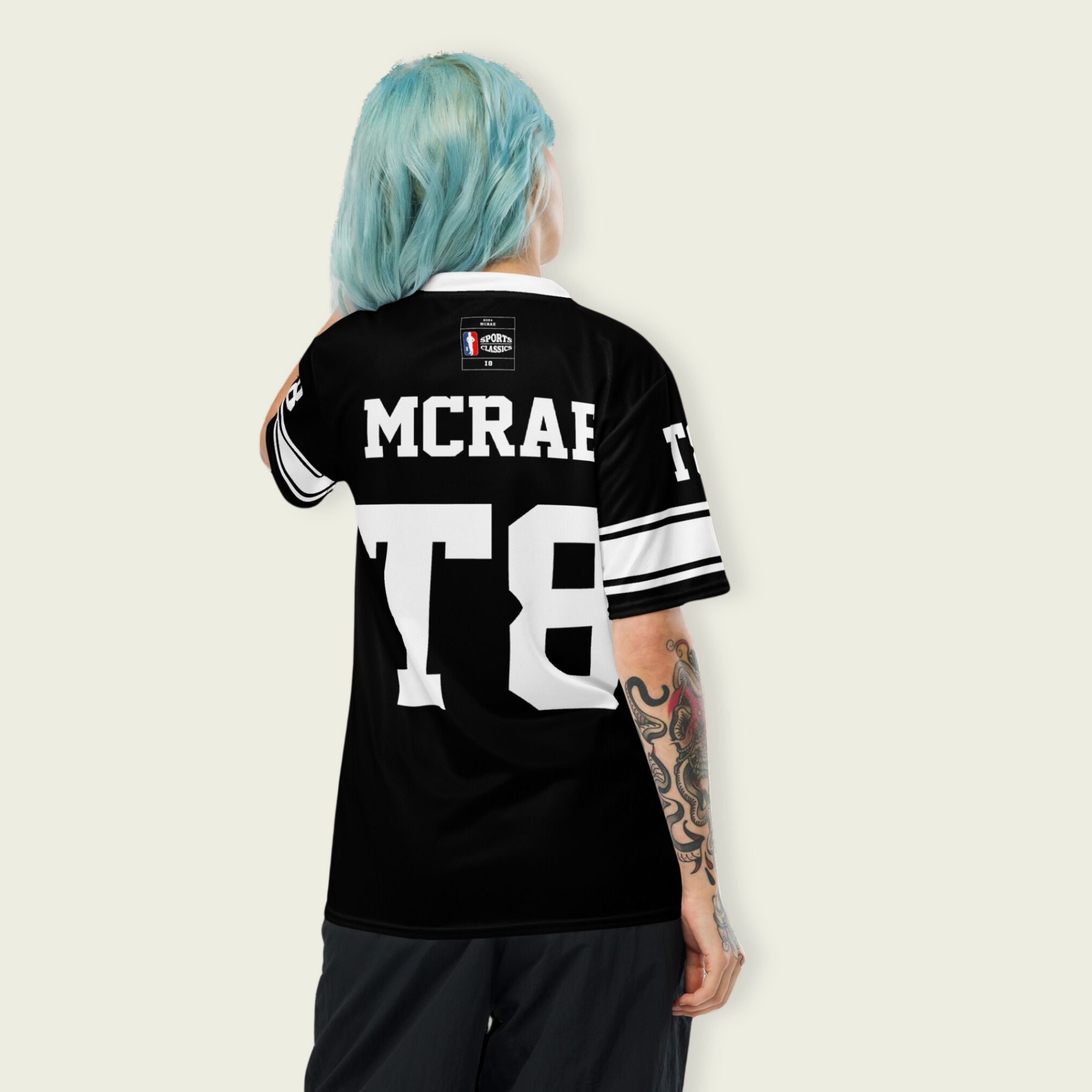 A black and white football jersey with Tate Mcare on the back and front in white with a white outline.