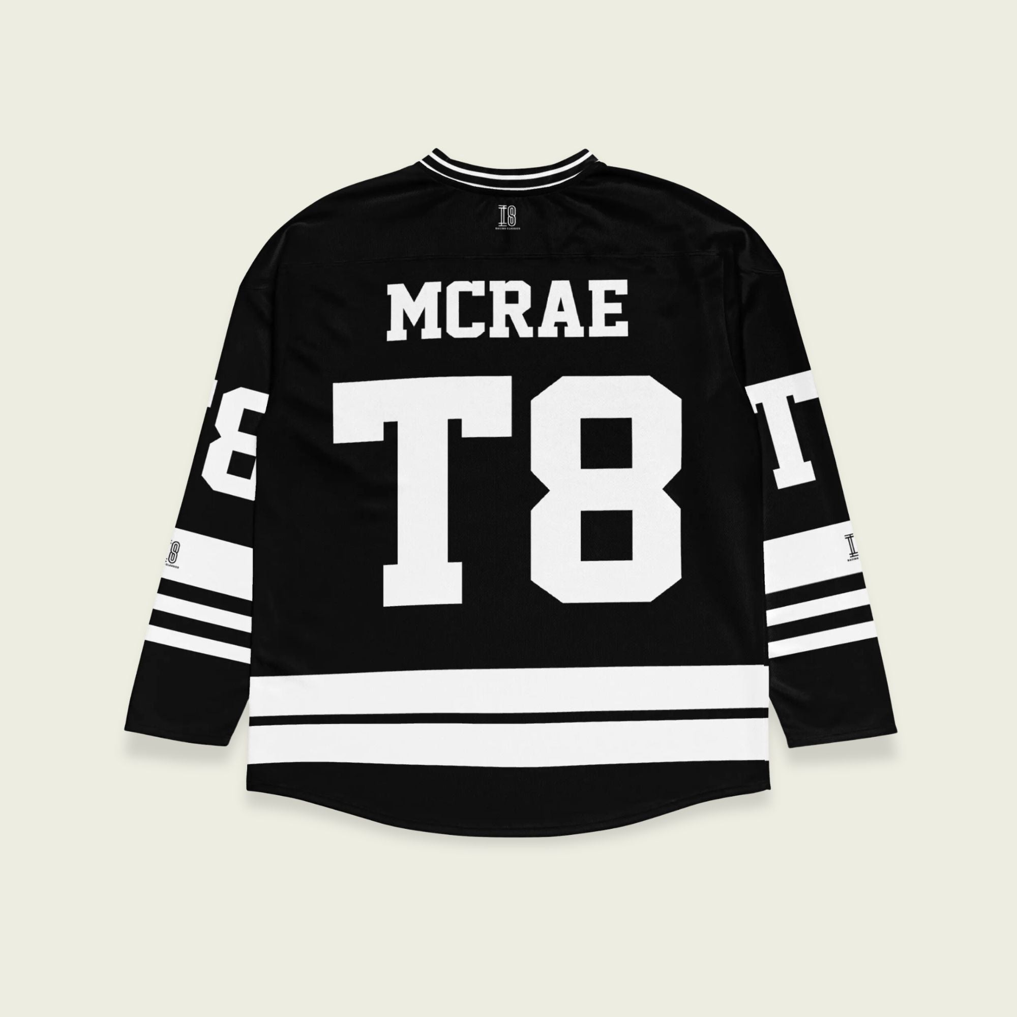 A black and white hockey jersey with the name Mcrae in white on the front and back. Also T8 in white on the front and back.