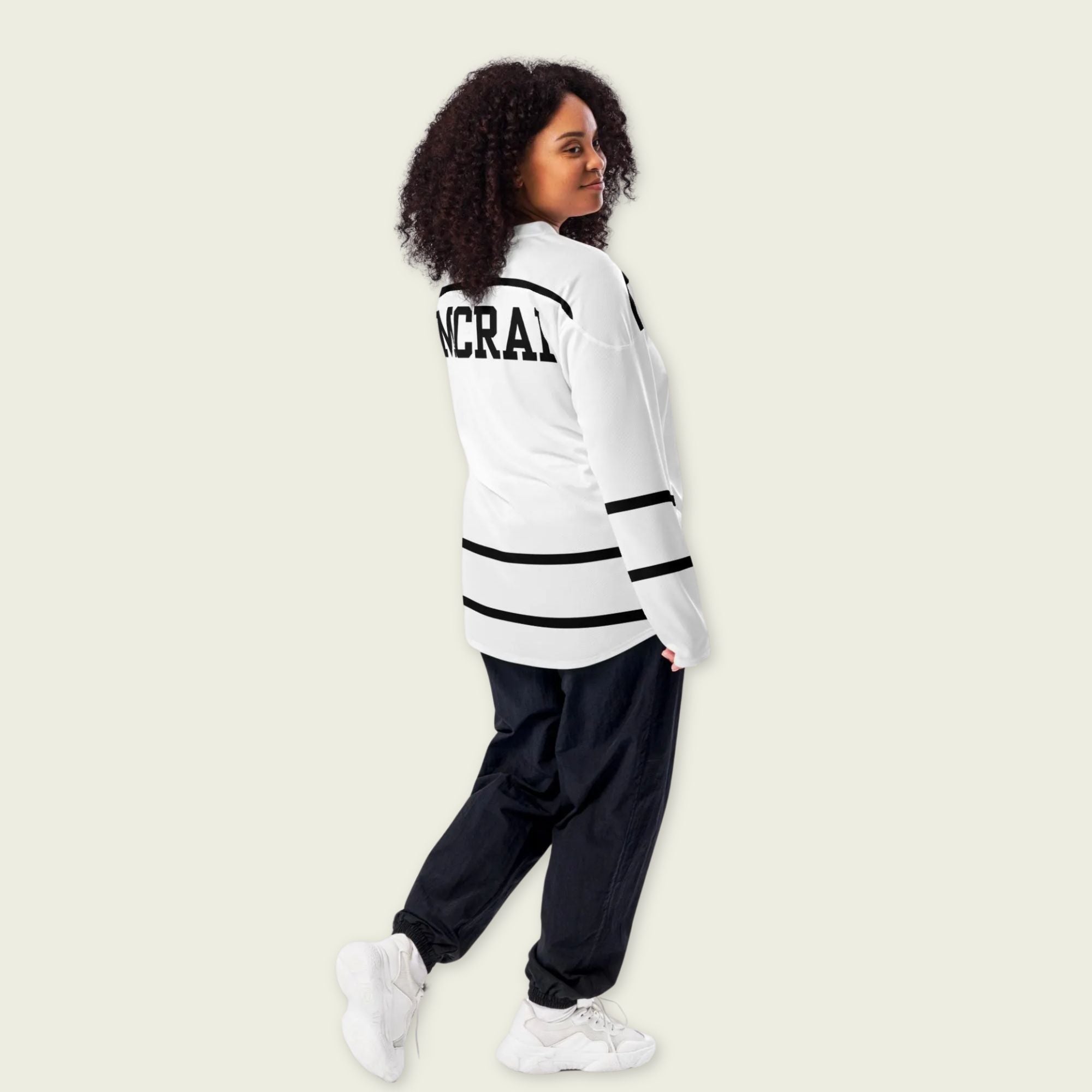 A Tate Mcrae white hockey jersey with black lines showing the name Mcrae in black on the back and T8 on the front.