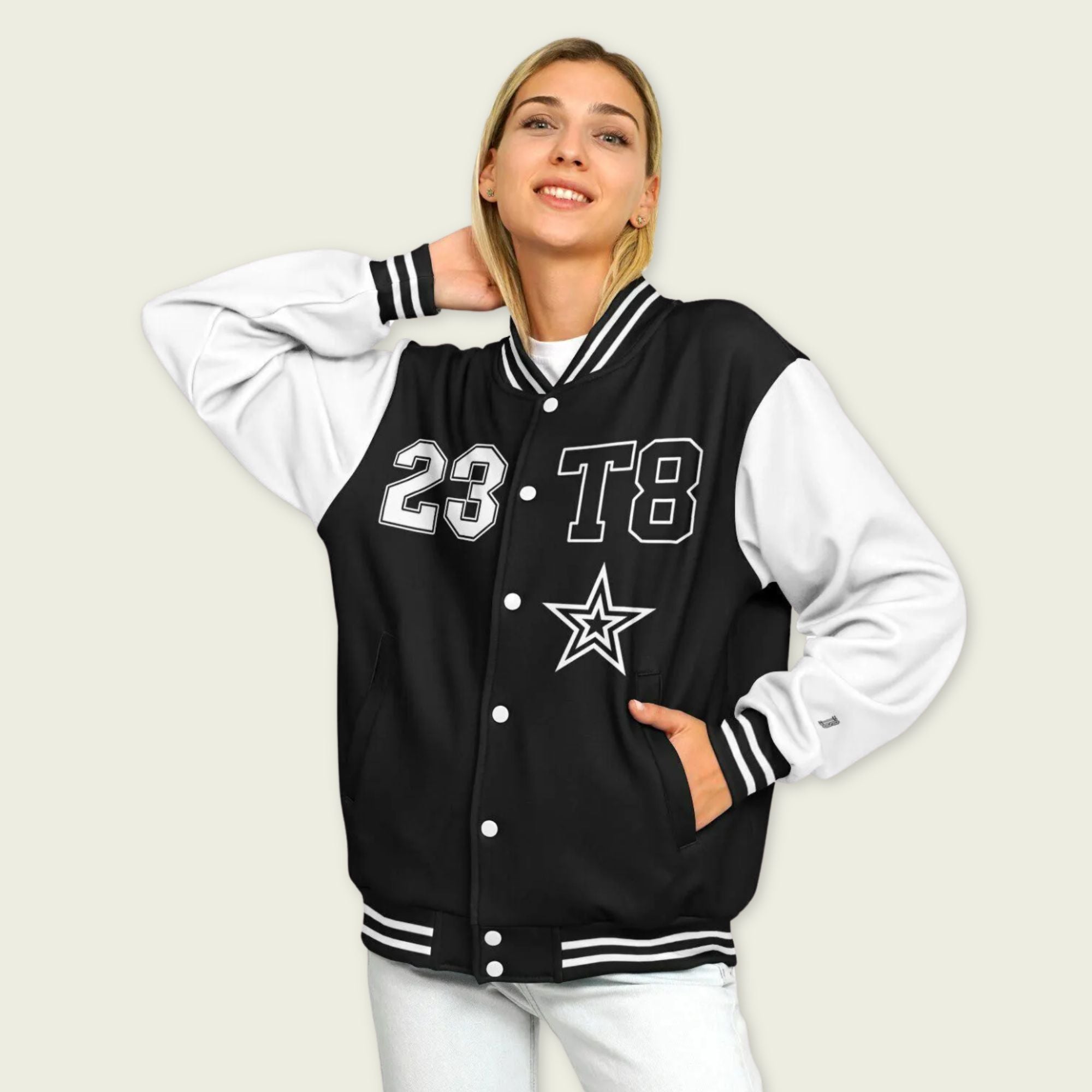 A black and white varsity jacket showing T8, 23, and Tate Mcrae in whte on the front and back.
