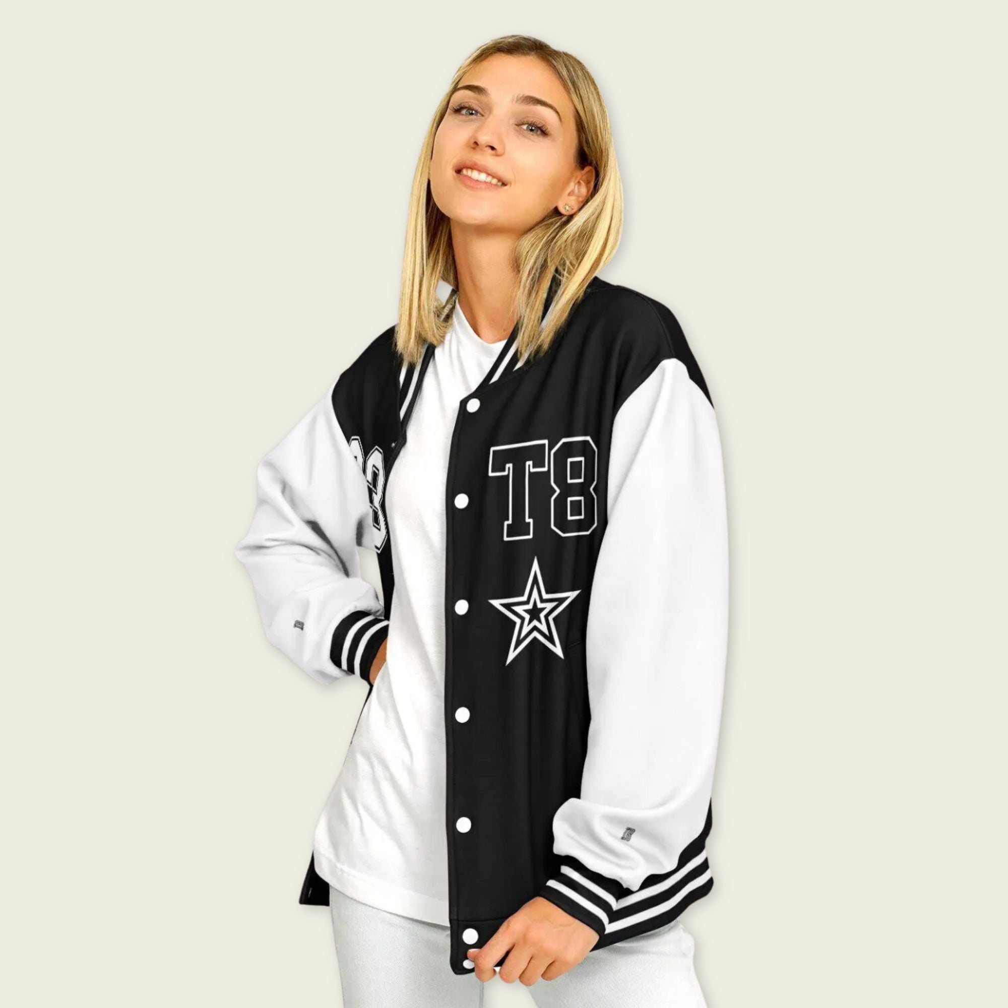 A black and white varsity jacket showing T8, 23, and Tate Mcrae in whte on the front and back.