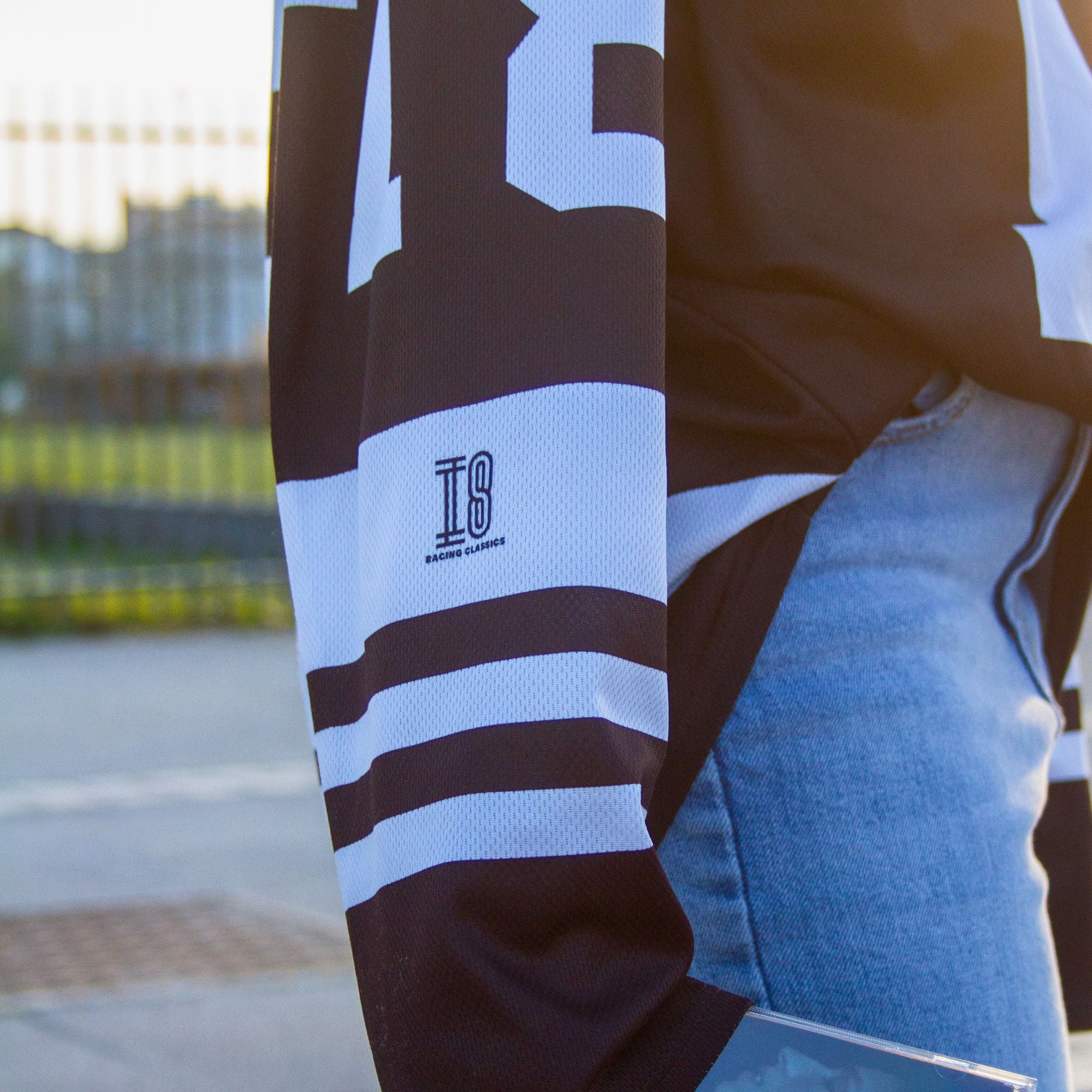 A black and white hockey jersey with the name Mcrae in white on the front and back. Also T8 in white on the front and back.