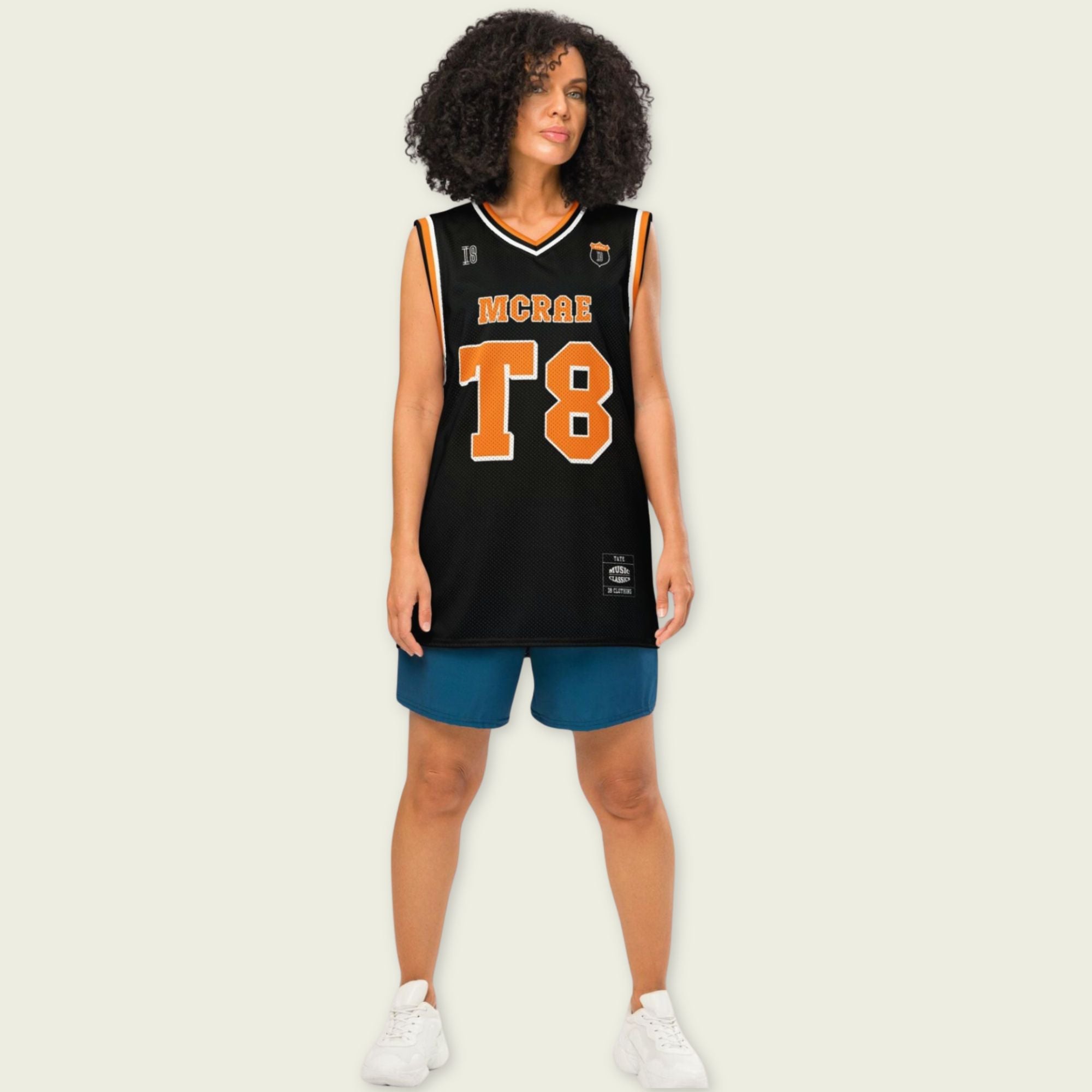 A black and orange pin striped basketball Jersey with T8 Tate Mcrae on the front and back in white.