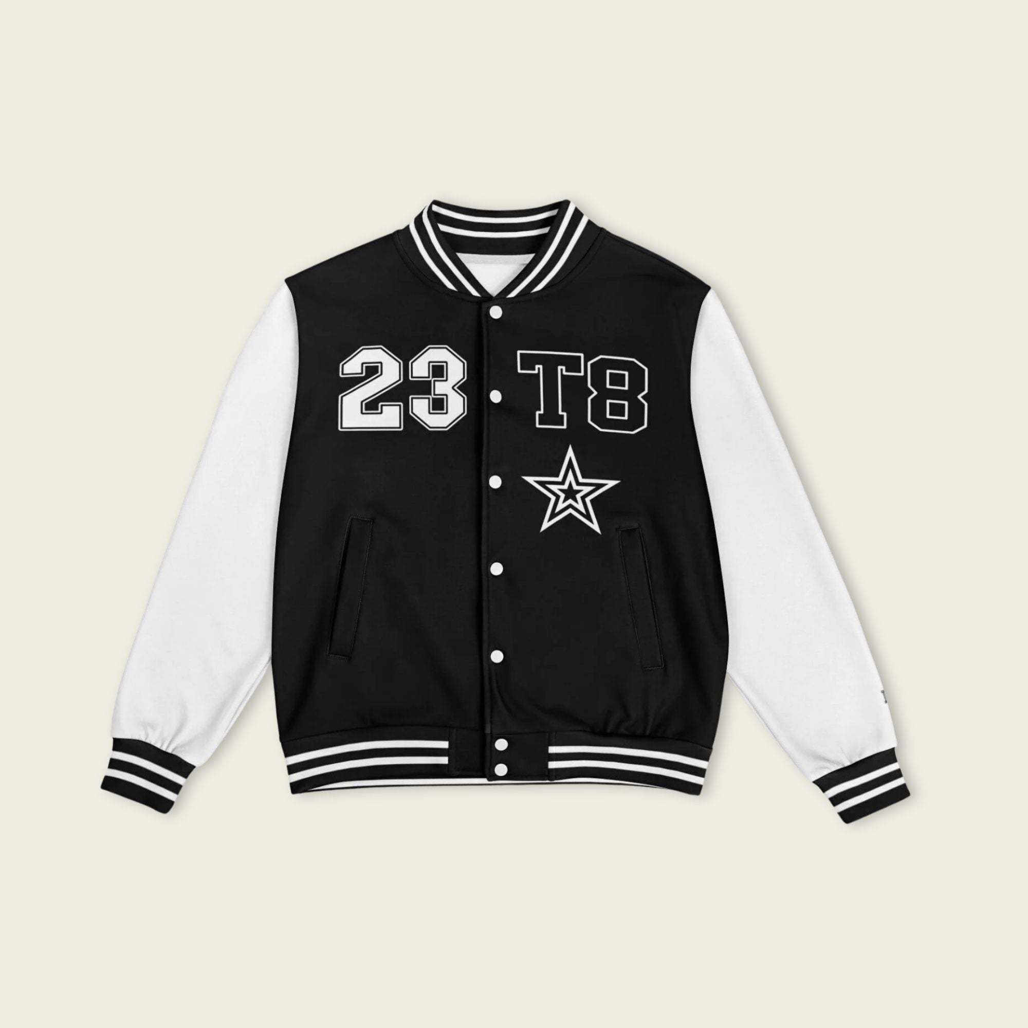 A black and white varsity jacket showing T8, 23, and Tate Mcrae in whte on the front and back.