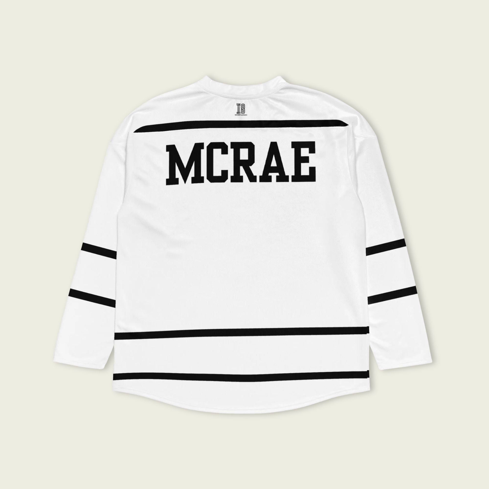 A Tate Mcrae white hockey jersey with black lines showing the name Mcrae in black on the back and T8 on the front.