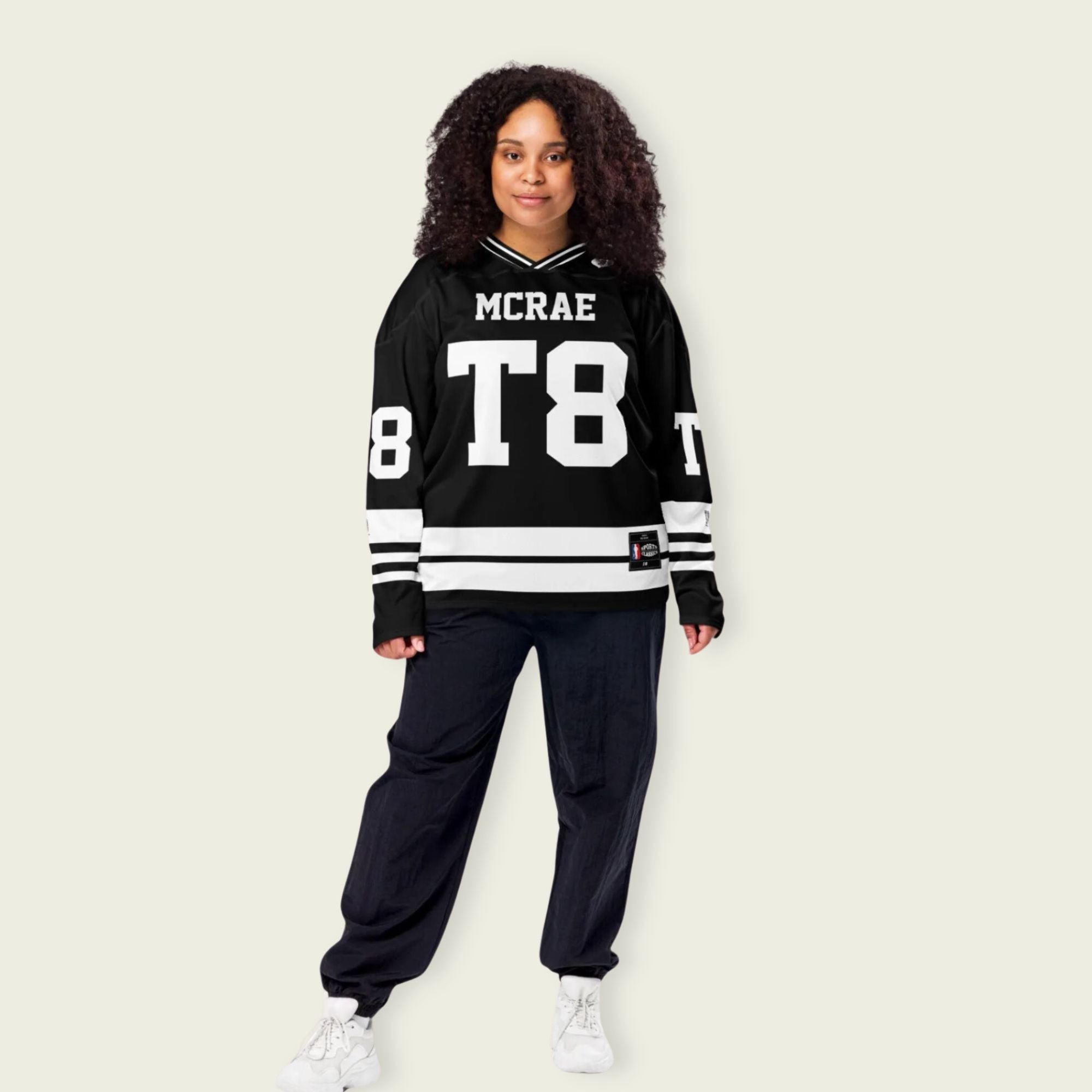 A black and white hockey jersey with the name Mcrae in white on the front and back. Also T8 in white on the front and back.