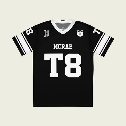 A black and white football jersey with Tate Mcare on the back and front in white with a white outline.