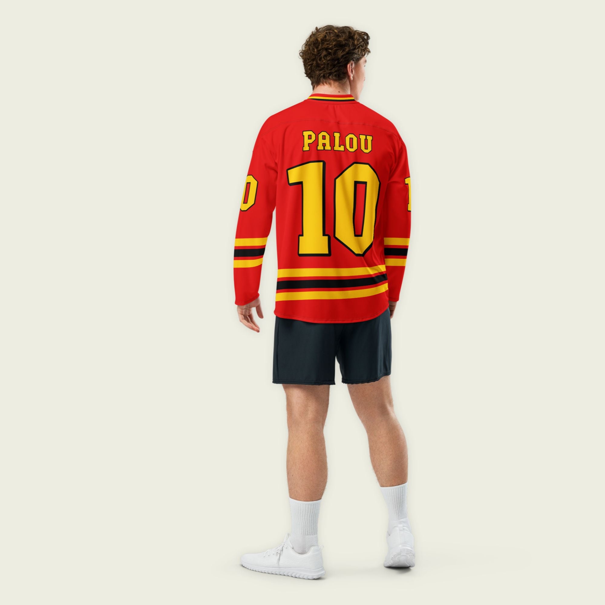 A red hockey jersey with Alex Palou's indycar racing number 10 on the front and back in yellow, also the name palou is on the back and front in yellow.