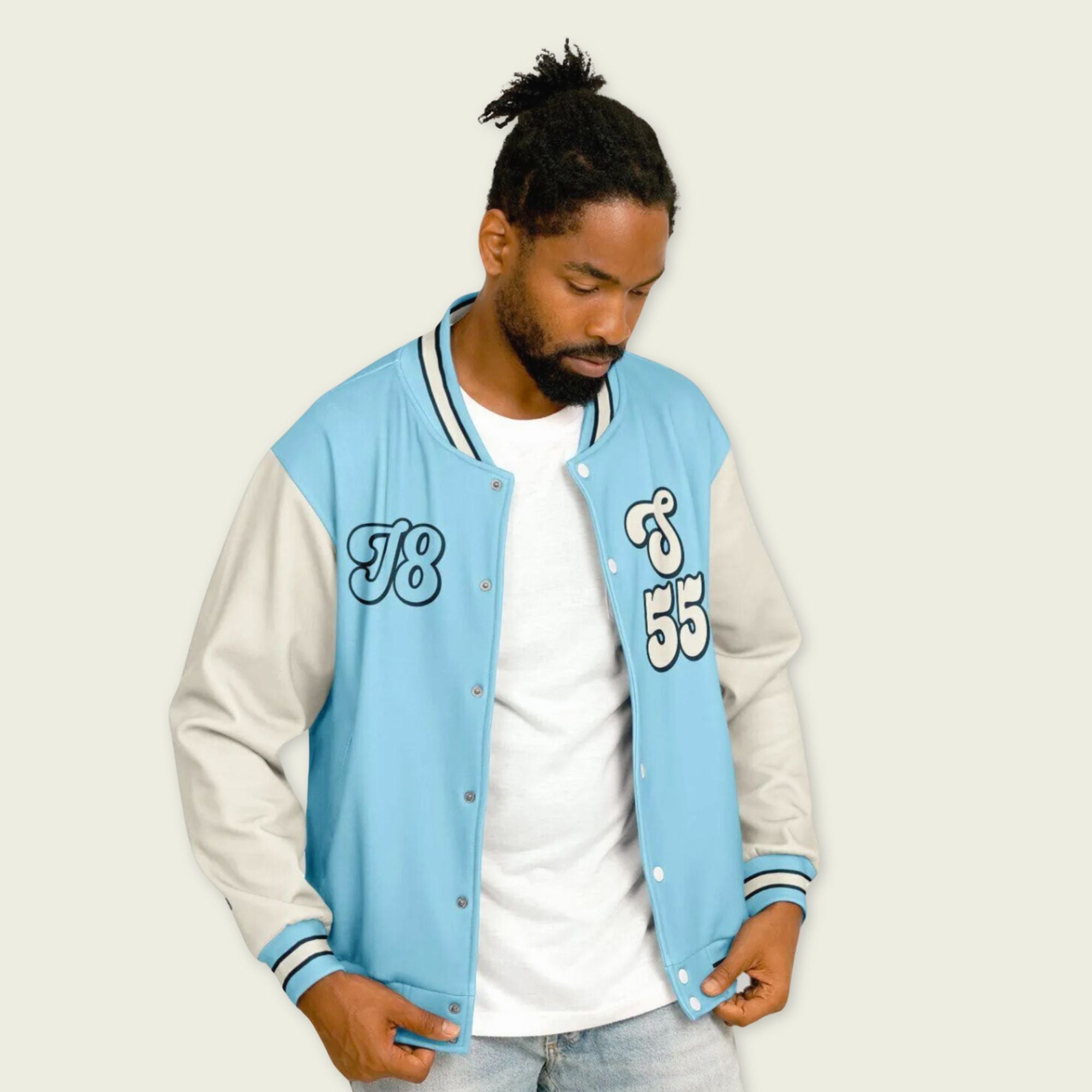 A baby blue and off white varsity jacket with Carlos Sainzs Williams F1 racing number 55 in white on the front and back.