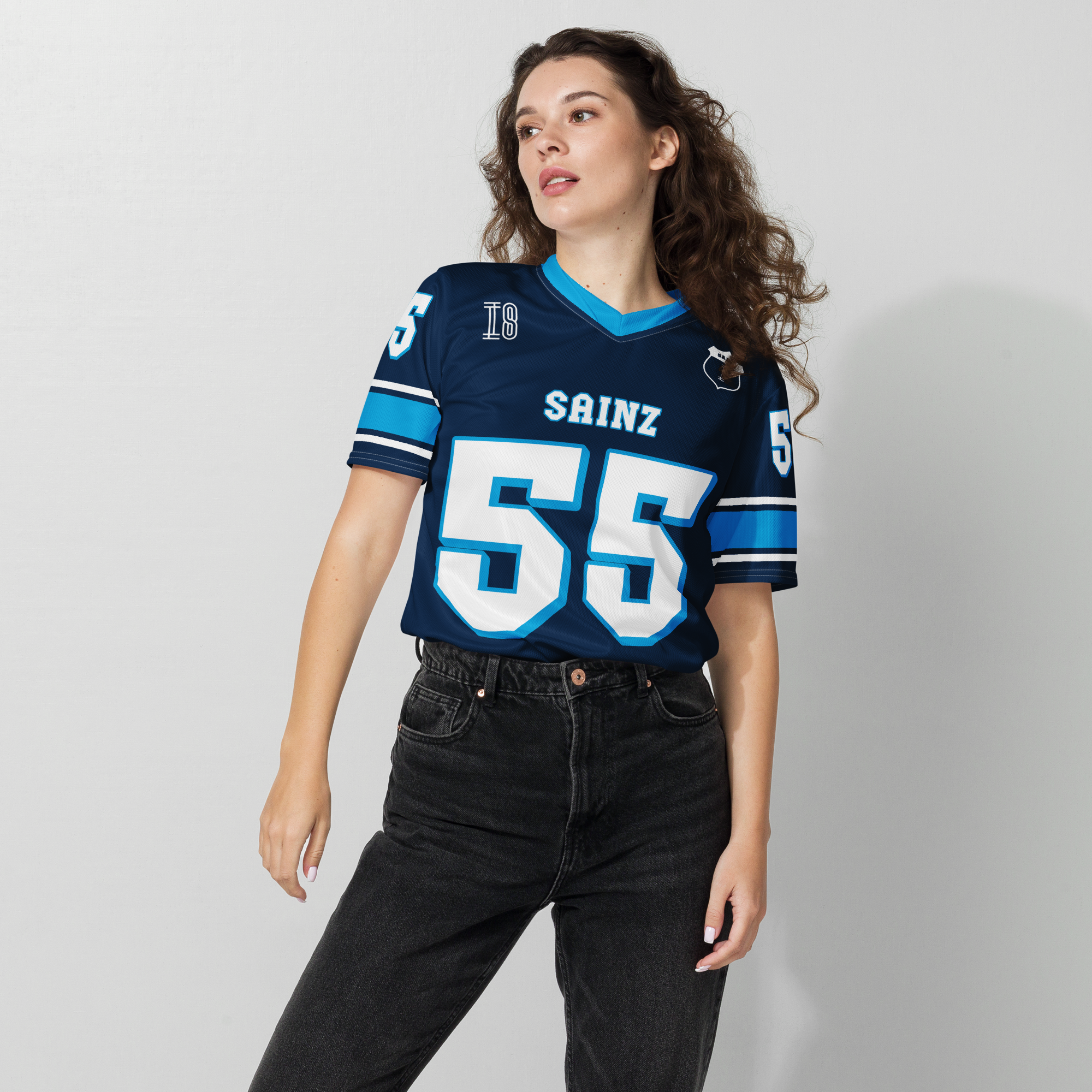 A navy blue football jersey with Carlos Sainz Jnr's WIlliams F1 racing number 55 on the back and front in white with a light blue outline.