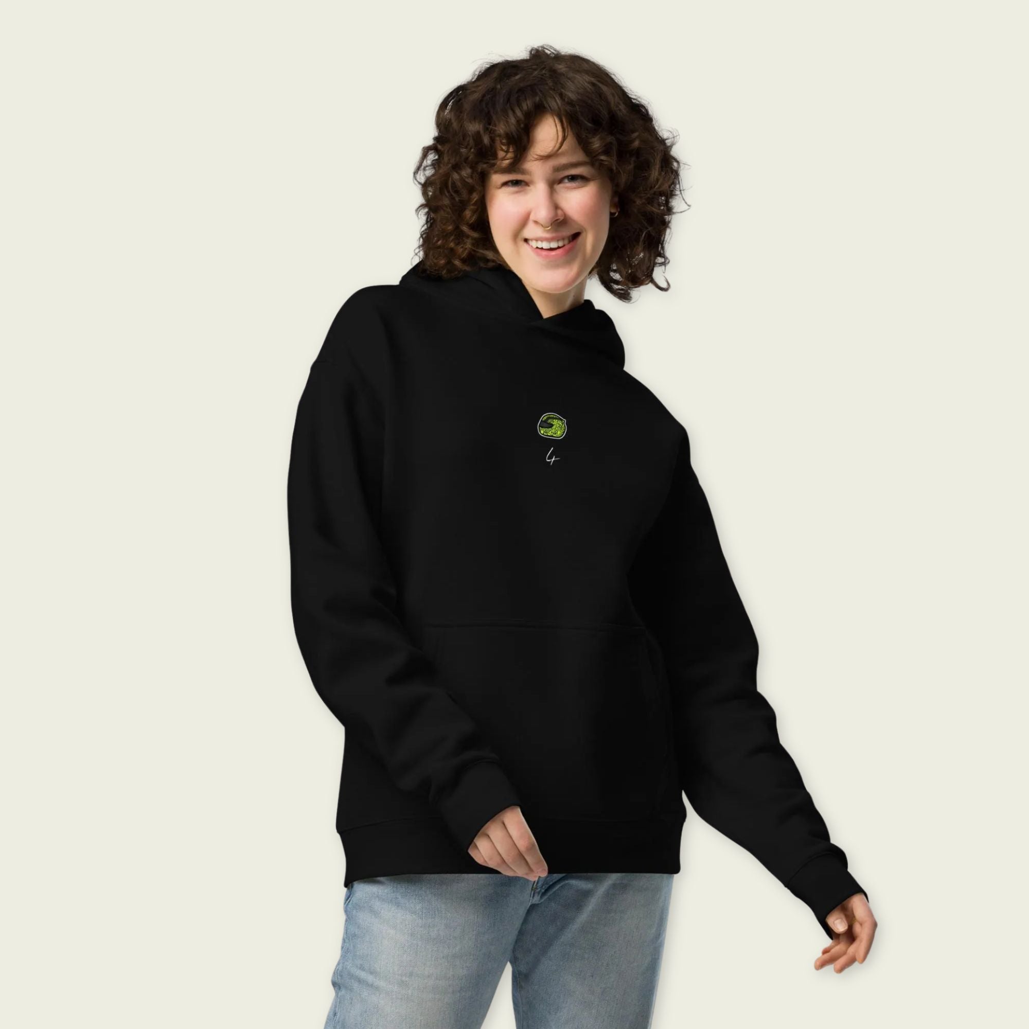 A black oversized hoodie with  white text Lando on the front  and lando norris's neon green helmut on the front.