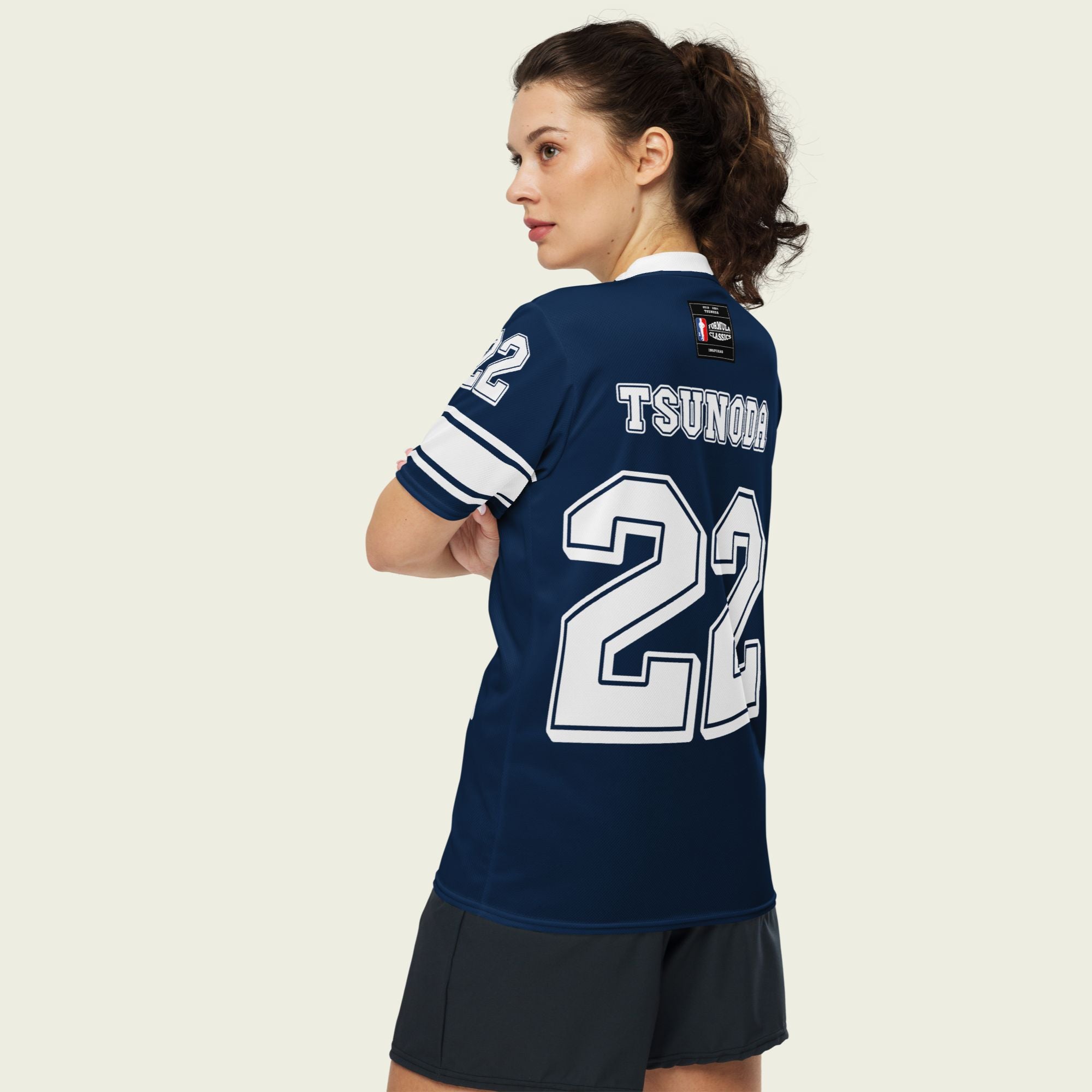 A navy blue and white football jersey it has Yuki Tsunoda's VCARB f1 racing number 22 on the front and back in white.
