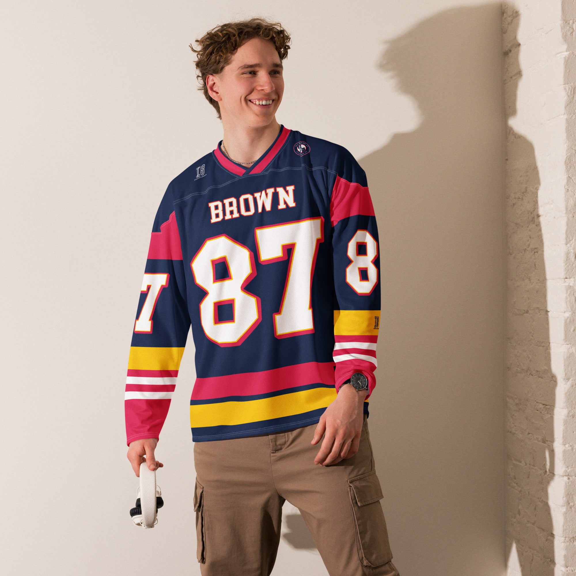 Person wearing a sports jersey with 'Brown' and number '87' on a plain background