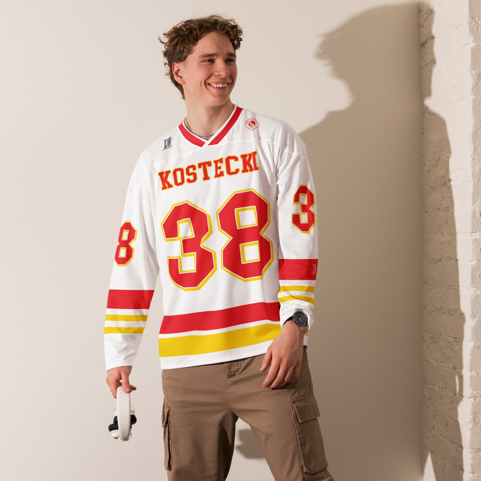 Person wearing a hockey jersey with 'Kostecki' and number '38' on a plain background
