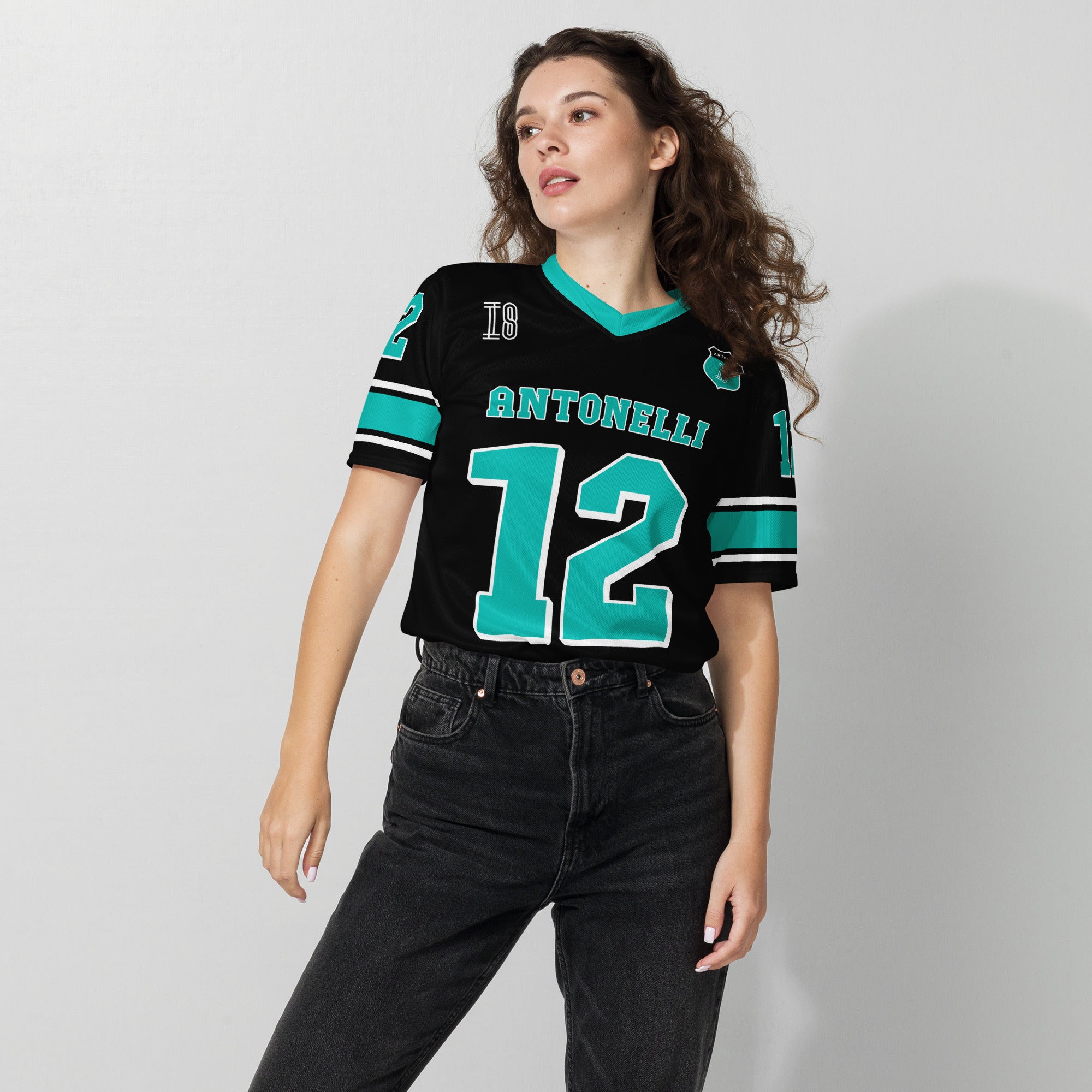 A black an turqoise colored football jersey with Kimi Antonelli's Mercedes F1 racing number 12 on the front and back