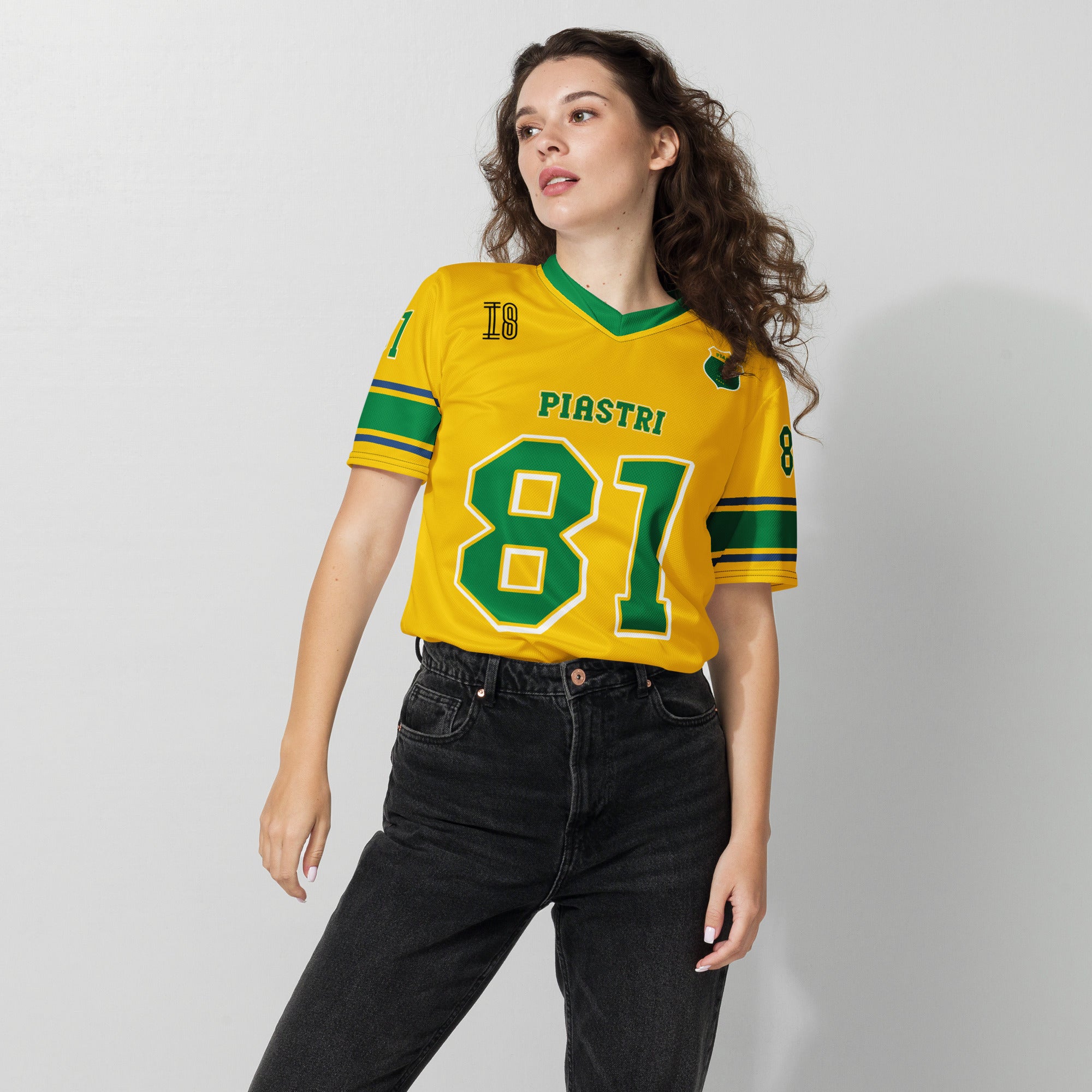 A Aussie green and gold football jersey with Oscar Piastri's McLaren  F1 racing number 81 on the back and front in green with a white outline.