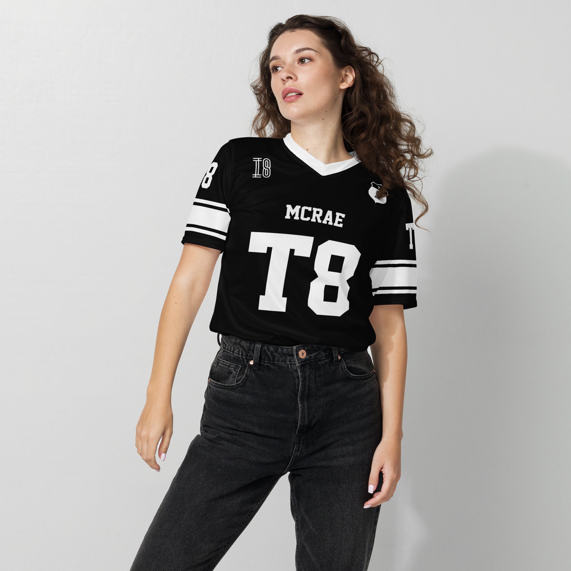 A black and white football jersey with Tate Mcare on the back and front in white with a white outline.