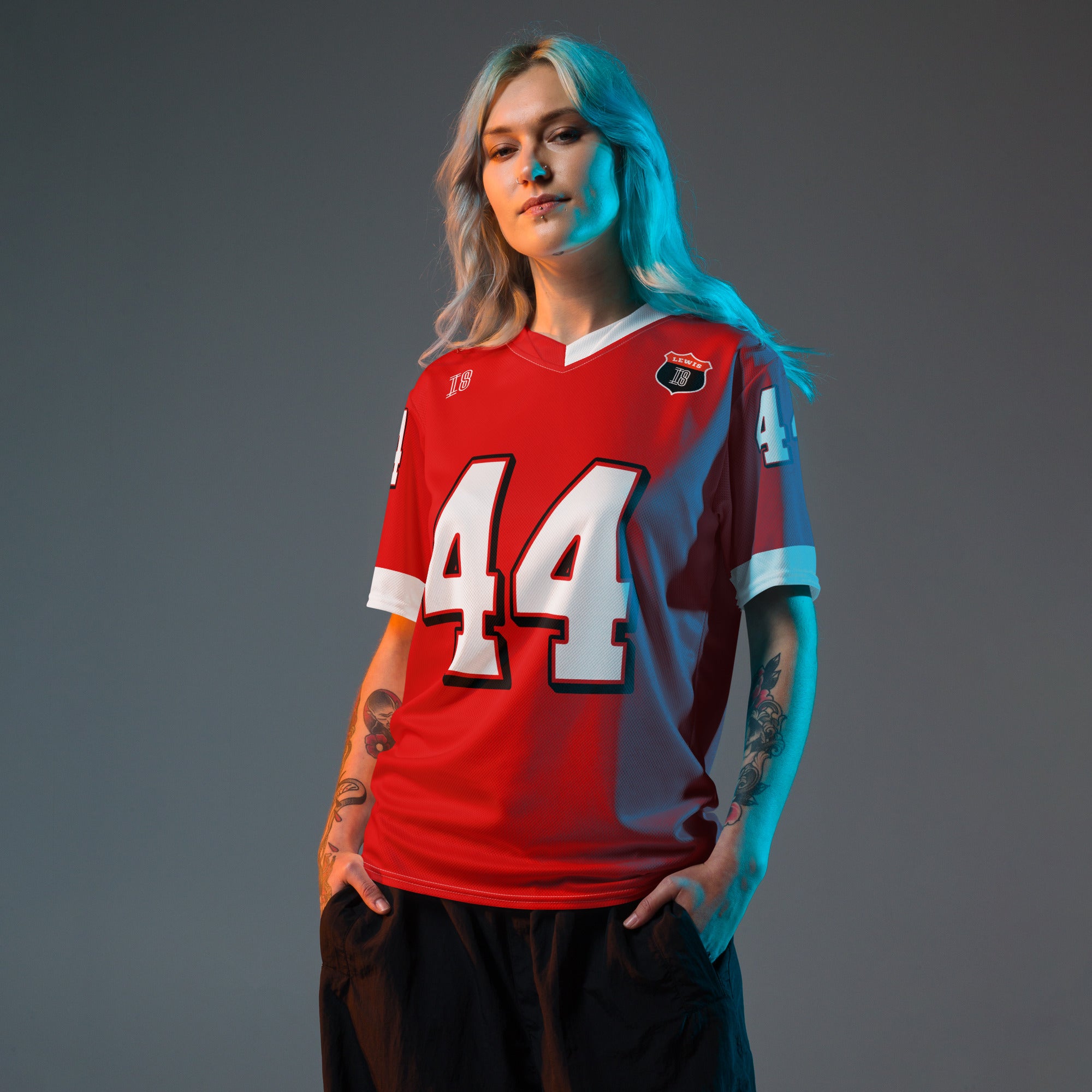 A red and white football jersey with Lewis Hamilton's Ferrari  F1 racing number 44 on the back and front in white. It has the name Hamilton in red on the front and back as well.