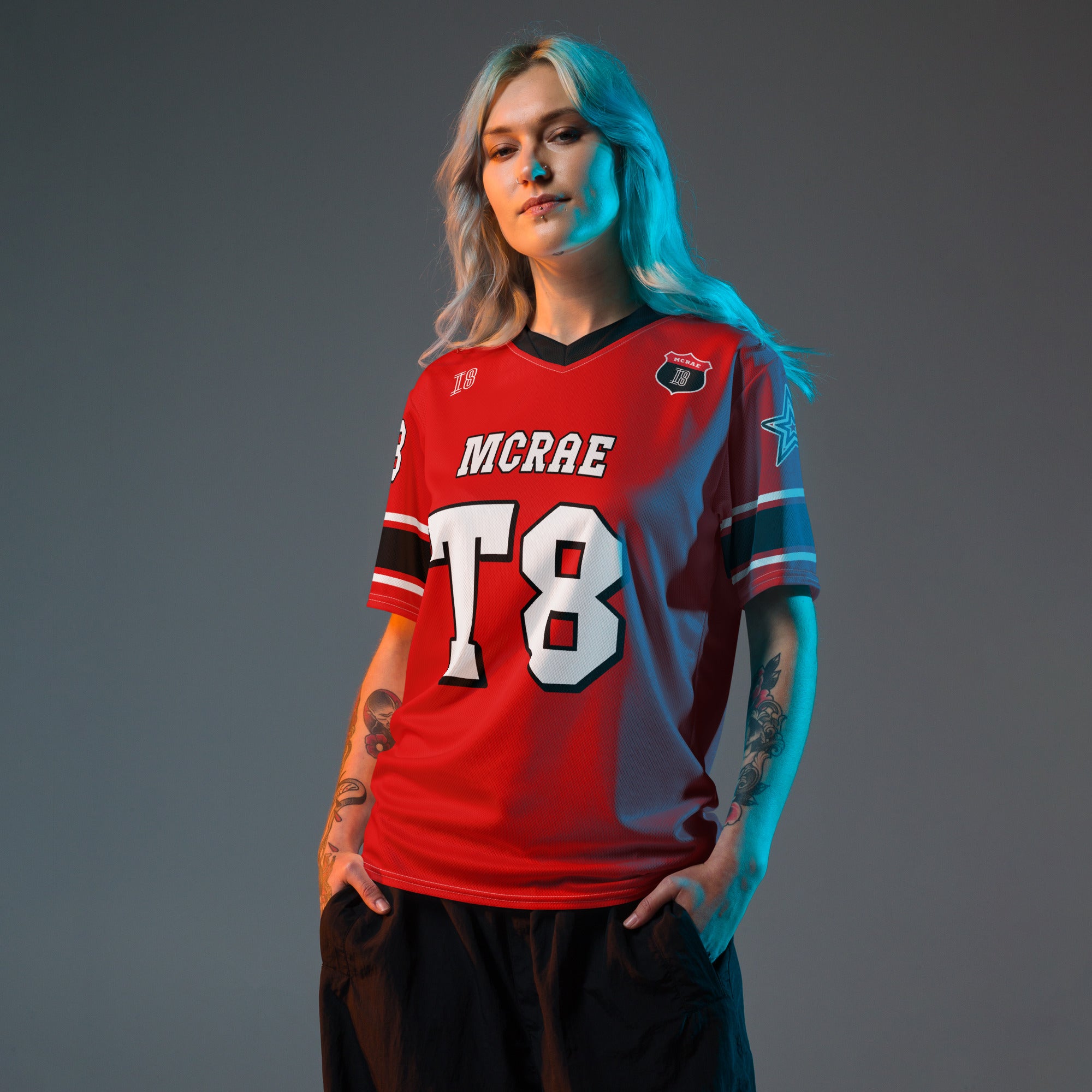 A red, black, and white football jersey with Tate Mcare on the back and front in white with a white outline.