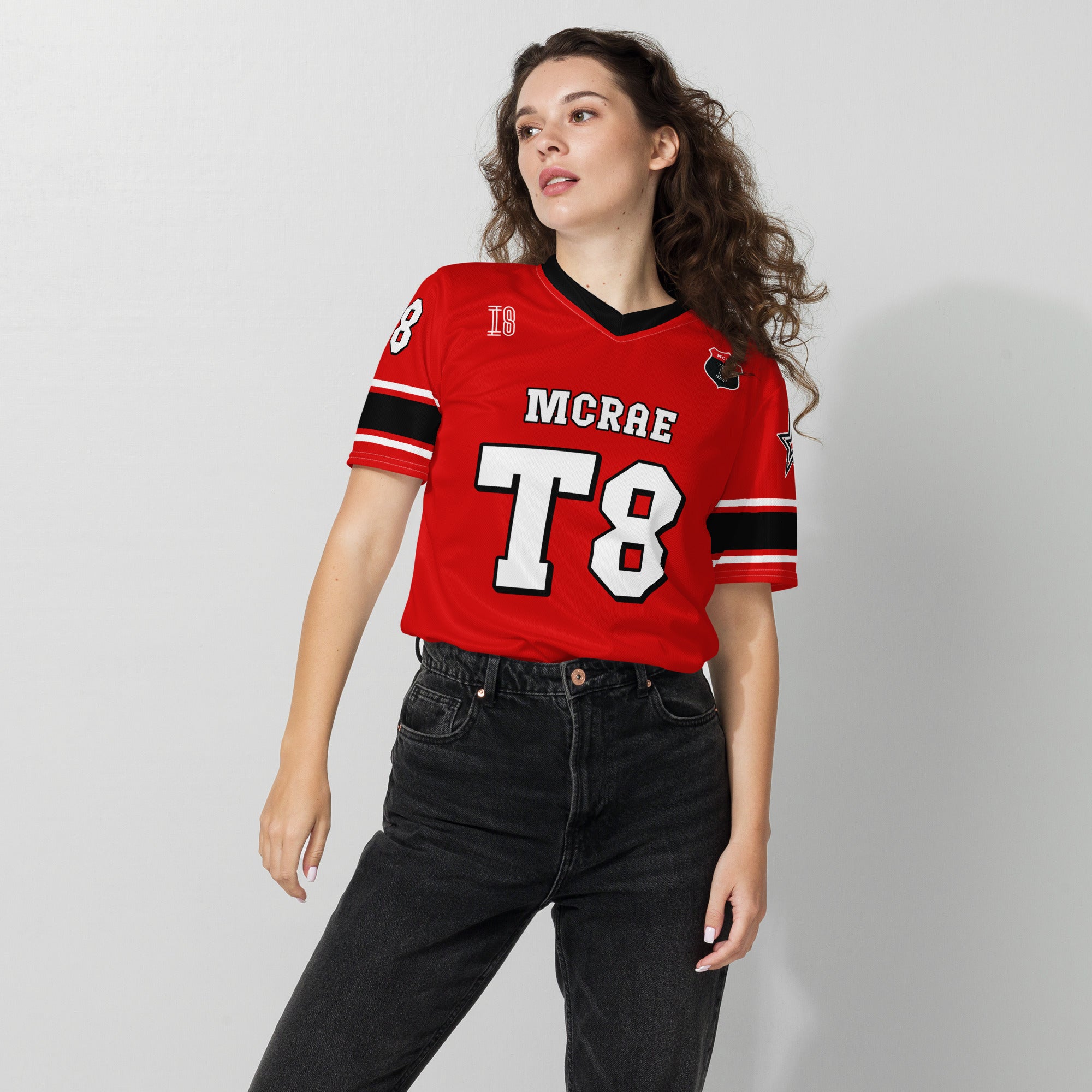 A red, black, and white football jersey with Tate Mcare on the back and front in white with a white outline.
