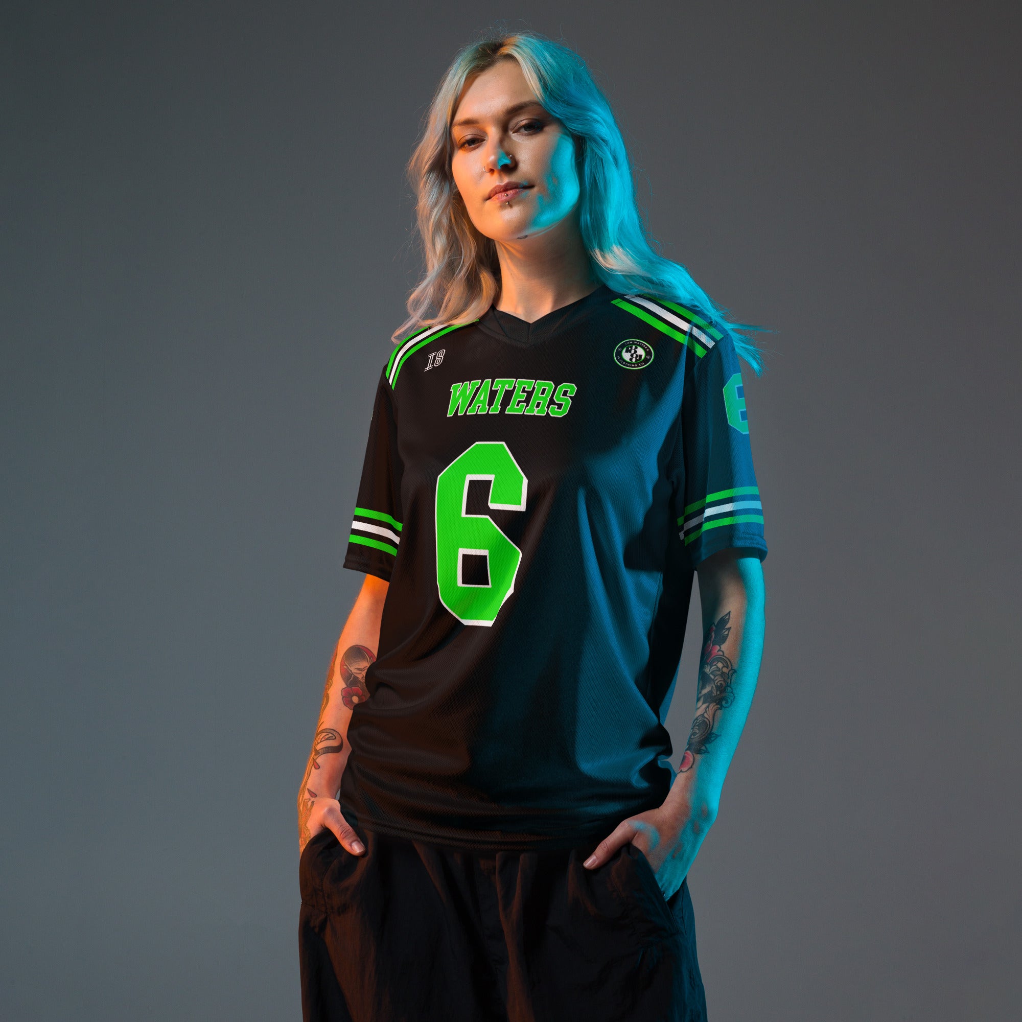 Person wearing a black sports jersey with green text and numbers on a gray background