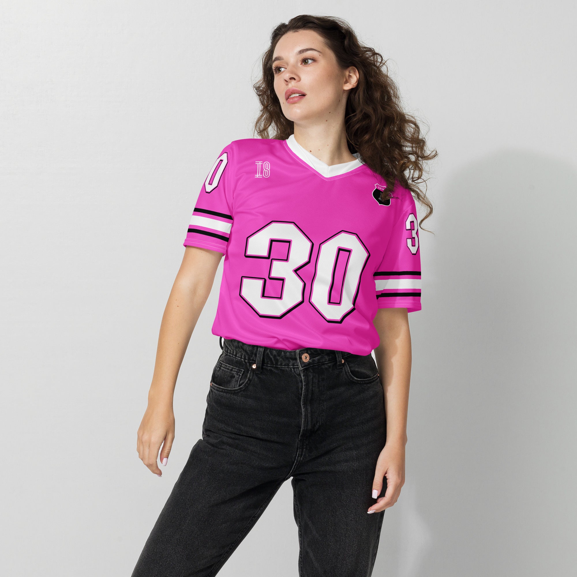 Person wearing a pink sports jersey with the number 30 on a plain background