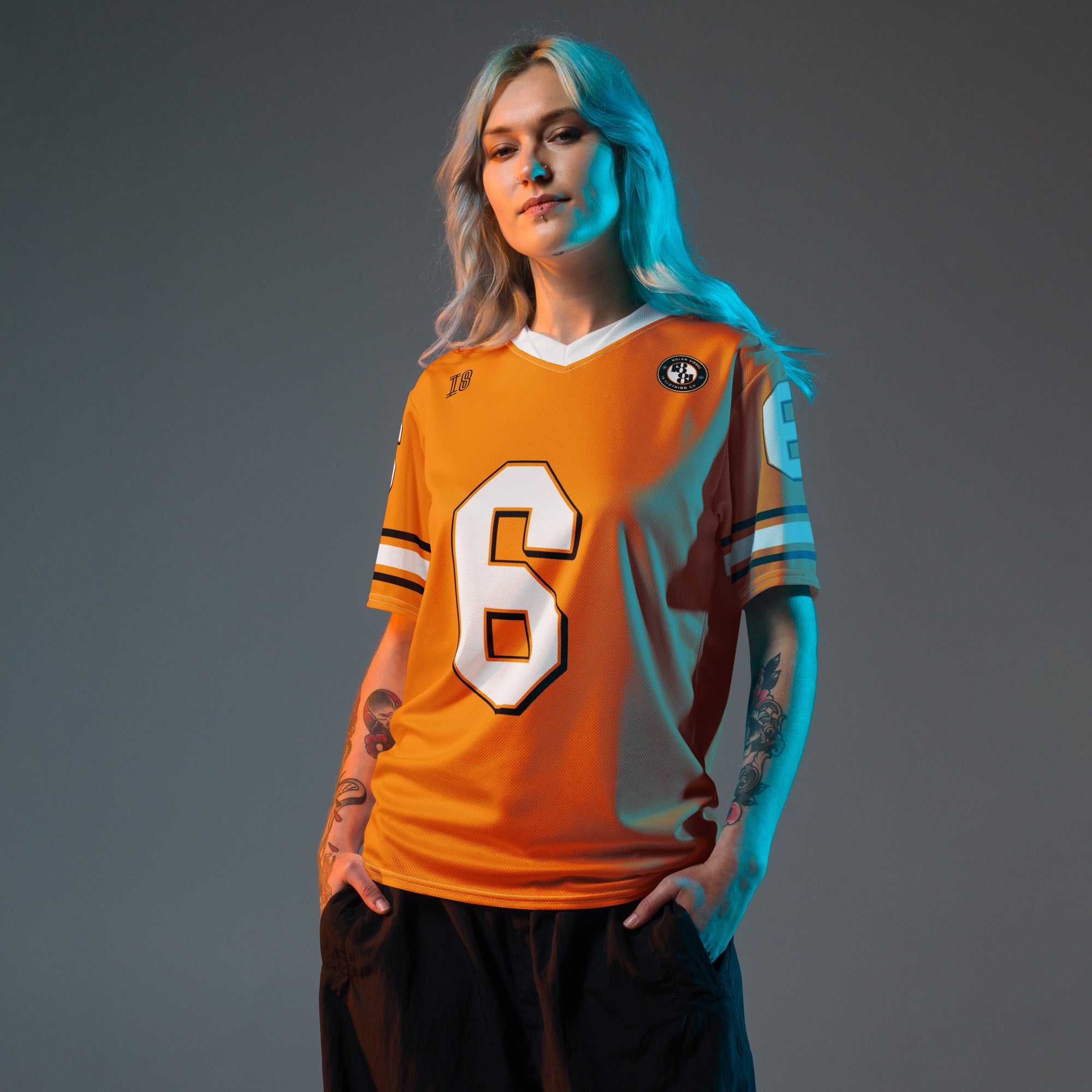 Person wearing an orange sports jersey with number 6 on a gray background