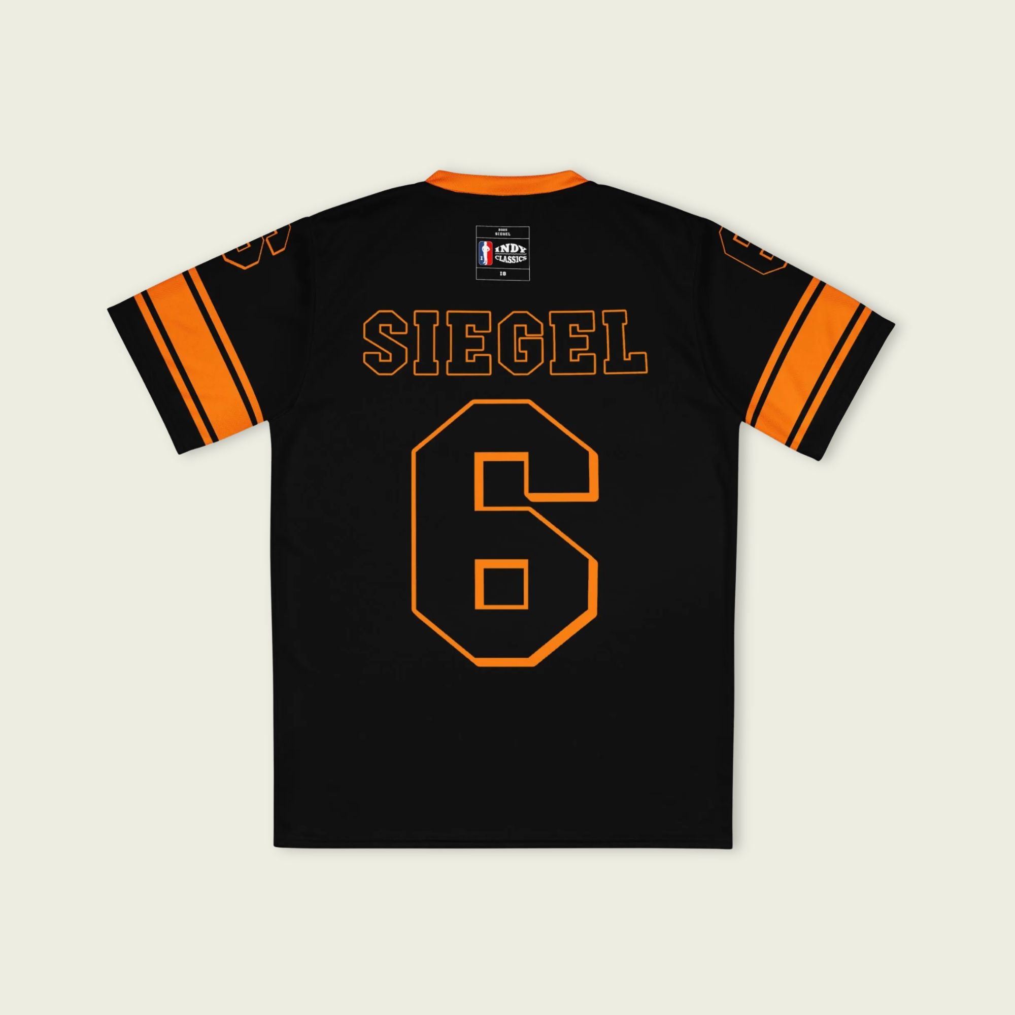 Black sports jersey with orange accents featuring the name 'SIEGEL' and number '6' on a beige background.