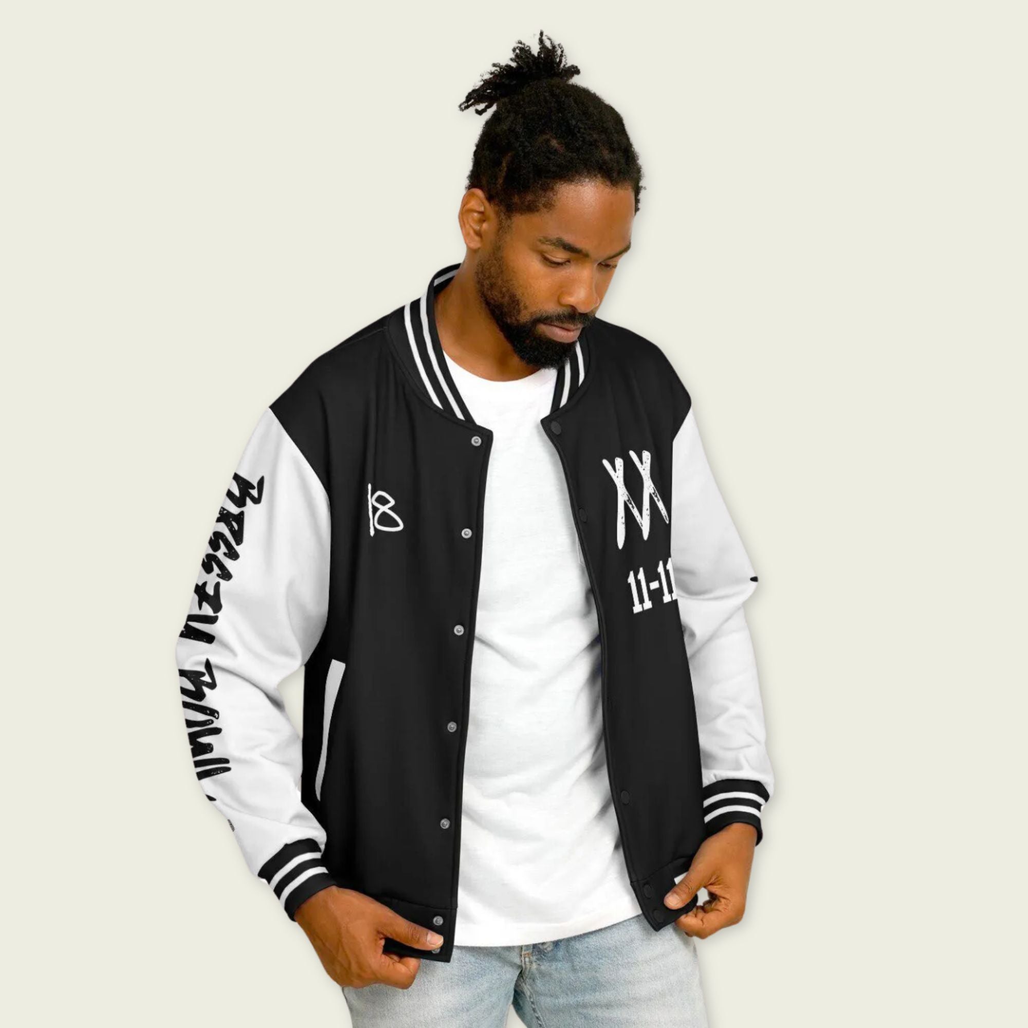 A black and white varsity jacket showing Chris Browns name Breezy on the back with XX and 11-11 breezy bowl tour