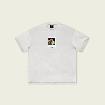 White t-shirt with a small graphic on a beige background