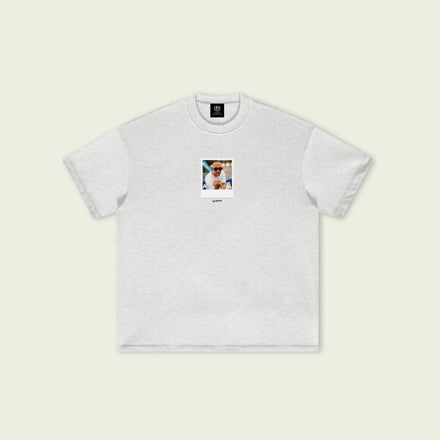 Gray t-shirt with a small graphic on a beige background