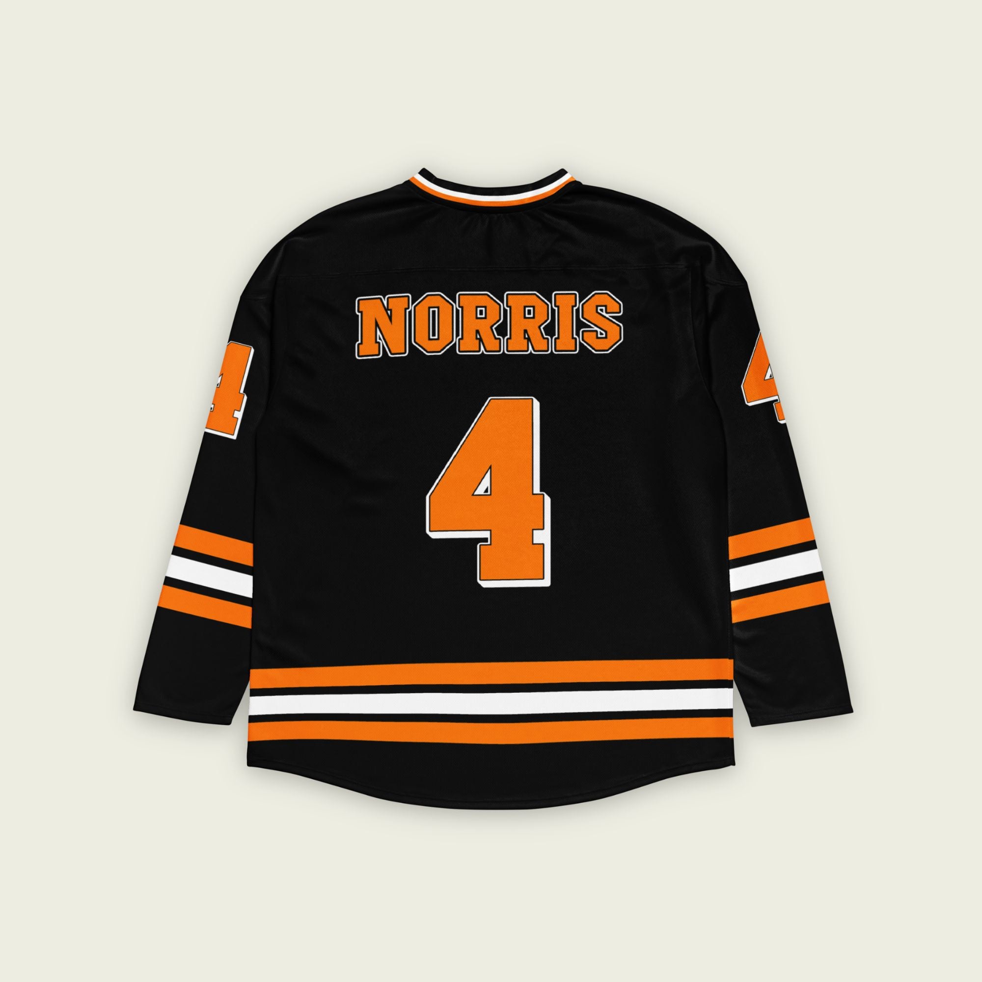A black hockey jersey with lando norris's mclaren F1 racing number 4 on the front and the black. it has oragne stripesin the top, bottom, and arms. WIth his last name norris on the front and back.