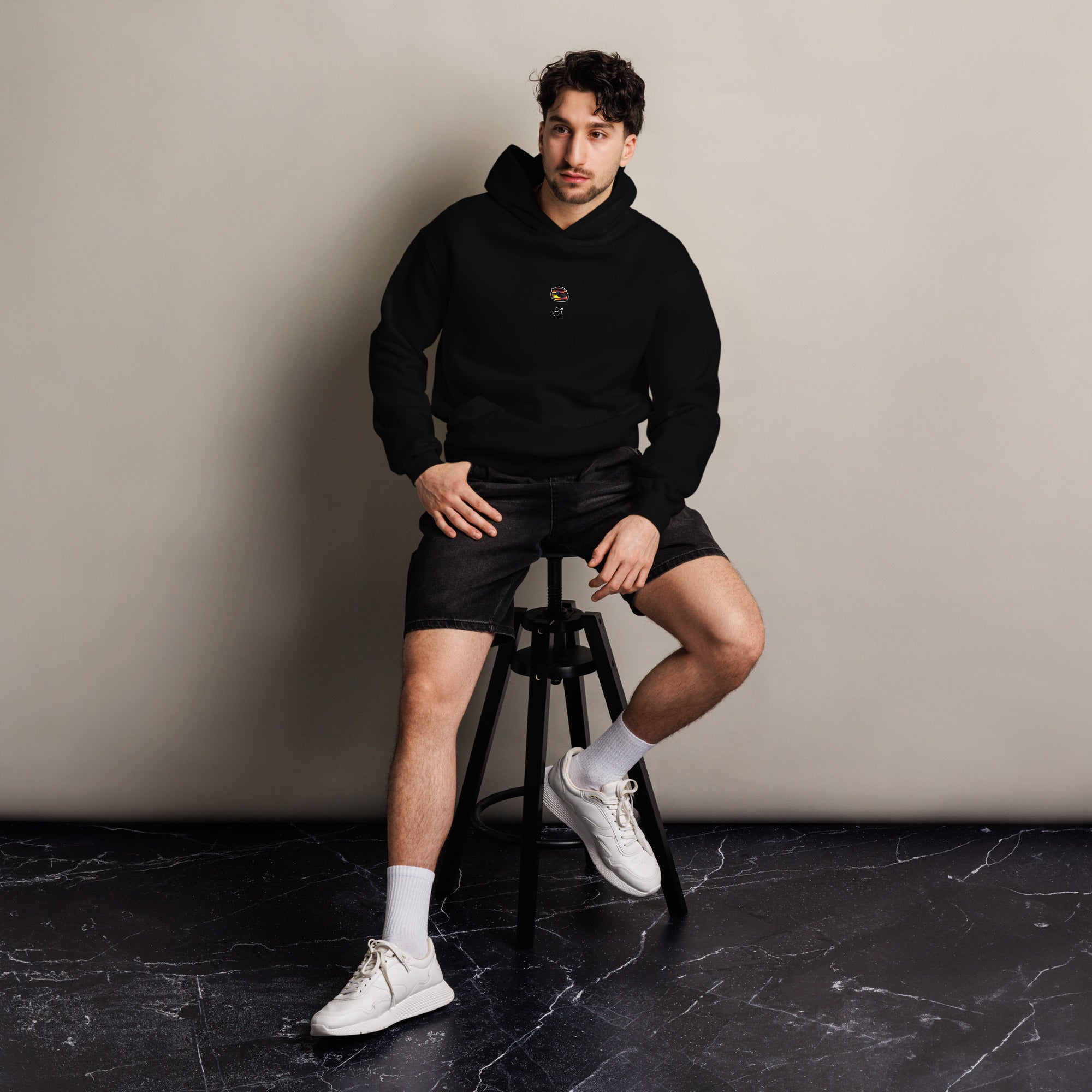 A black oversized hoodie with white text Osacr Piastris racing number 81 on the front and Osacr's graphic helmut on the front.