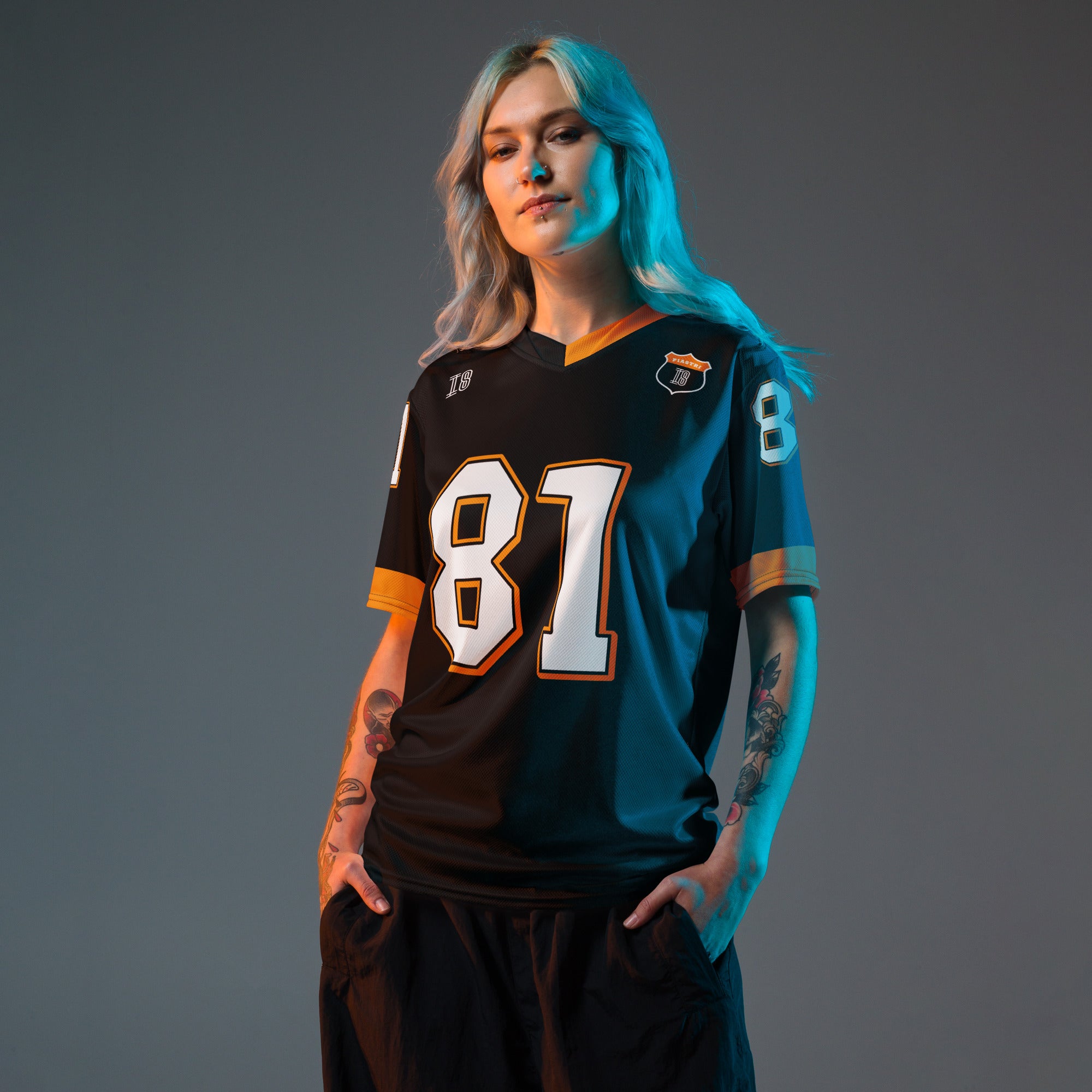 A black and papaya orange football jersey with Oscar Piastri's McLaren F1 racing number 81 on the back and front in white. It has the name Piastri in orange on the front as well.