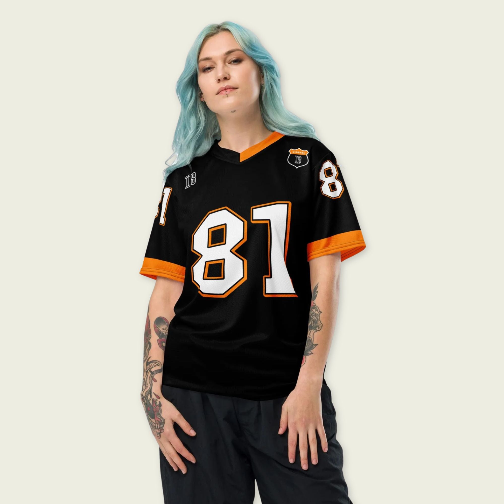 A black and papaya orange football jersey with Oscar Piastri's McLaren F1 racing number 81 on the back and front in white. It has the name Piastri in orange on the front as well.
