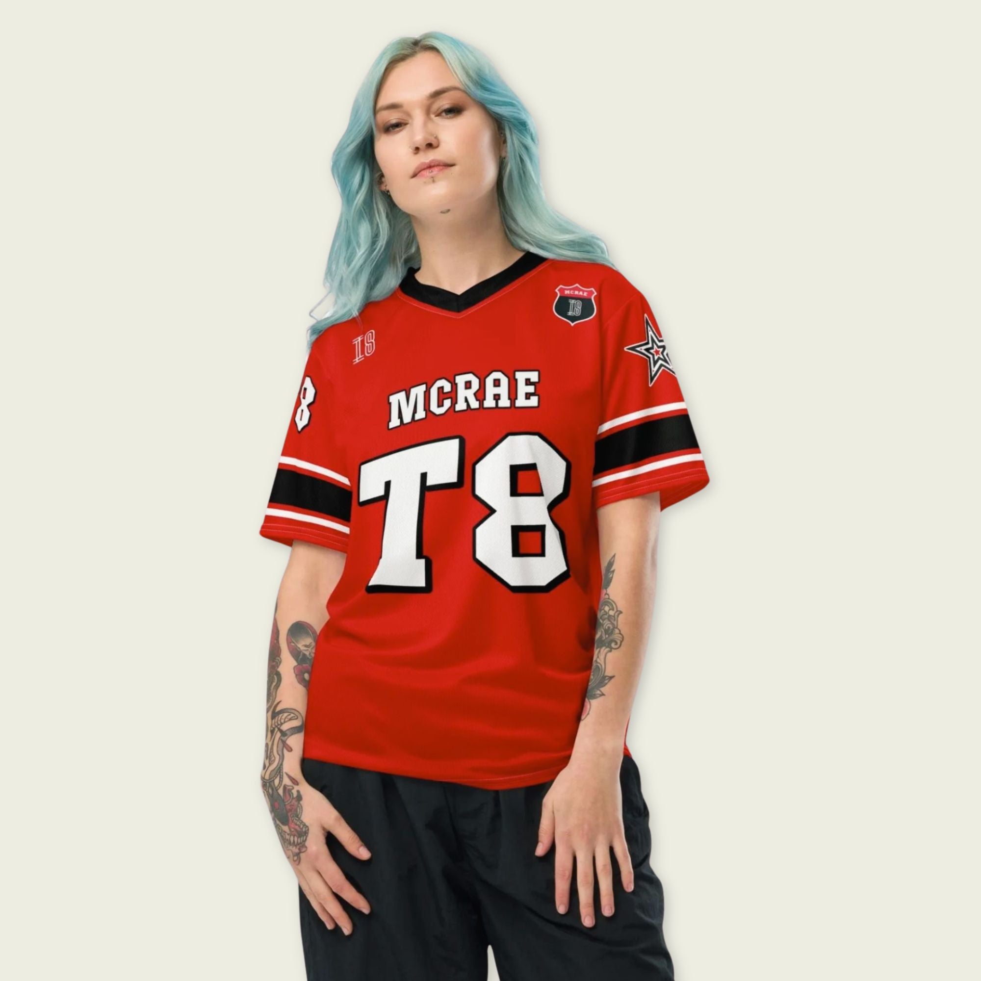 A red, black, and white football jersey with Tate Mcare on the back and front in white with a white outline.