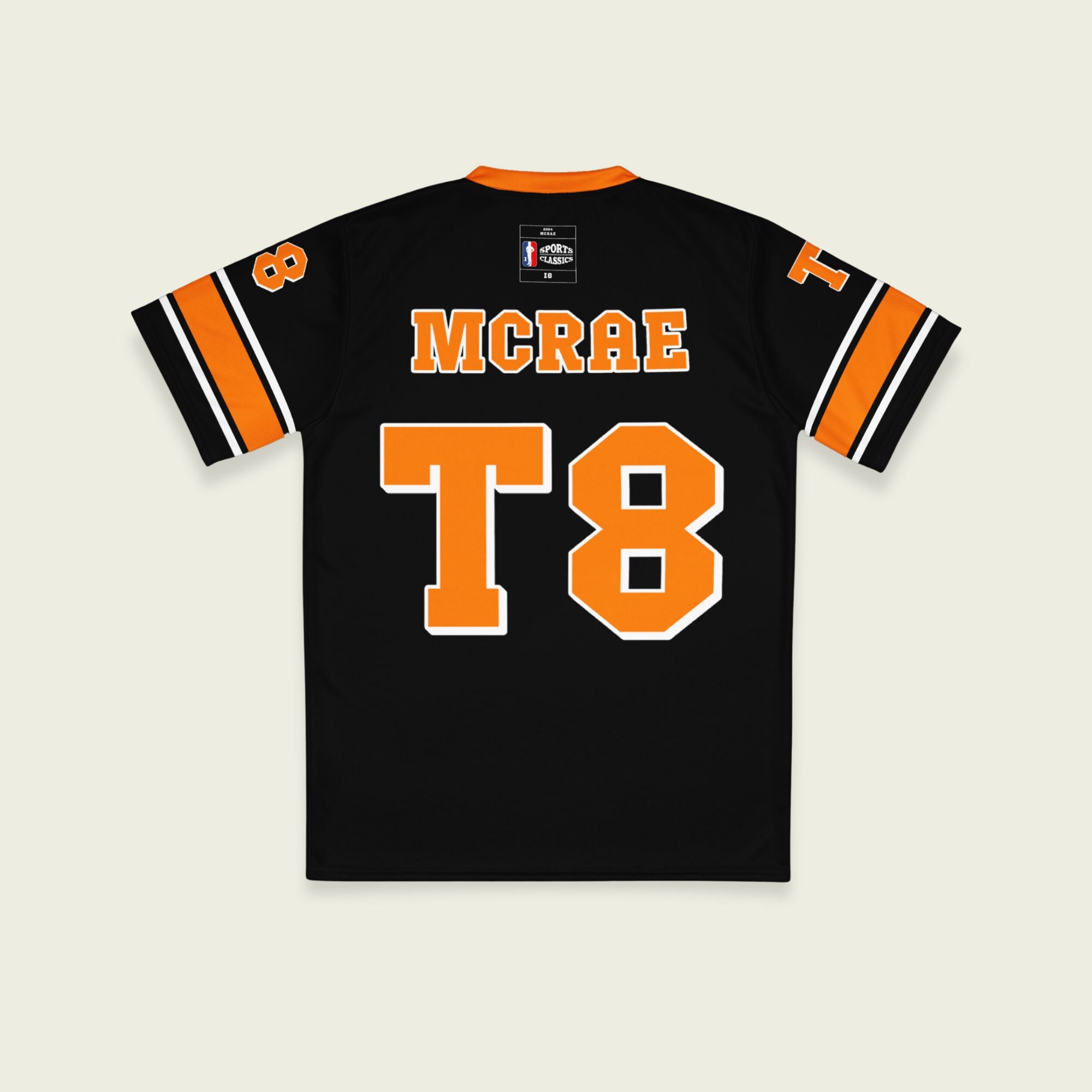 A orange, black. and white football jersey with Tate Mcare on the back and front in orange with a white outline.