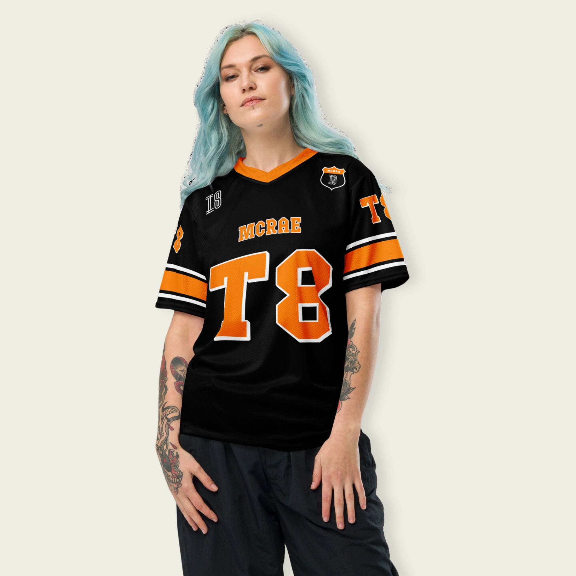 A orange, black. and white football jersey with Tate Mcare on the back and front in orange with a white outline.