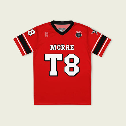 A red, black, and white football jersey with Tate Mcare on the back and front in white with a white outline.
