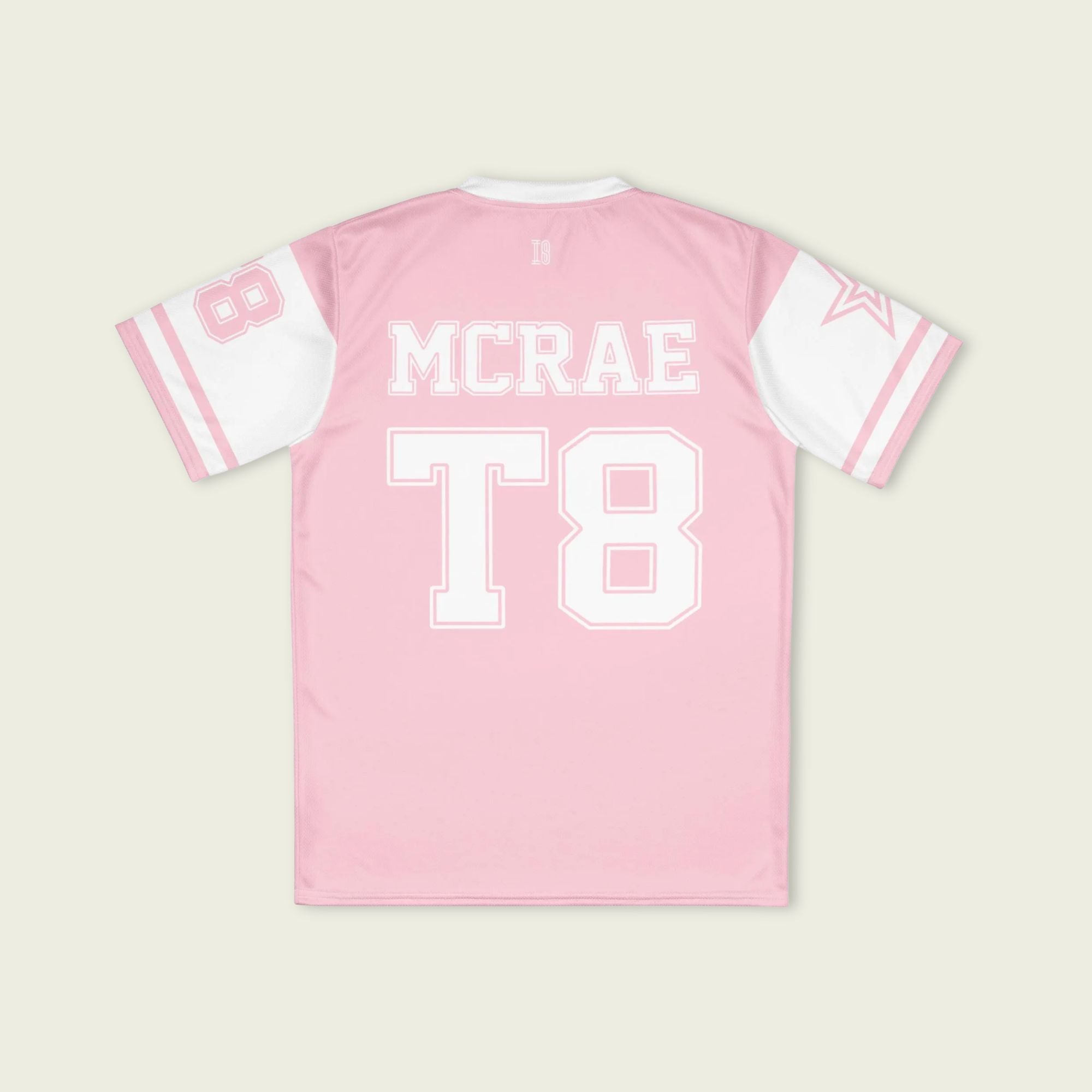 A pink and white football jersey with Tate Mcare on the back and front in white with a white outline.