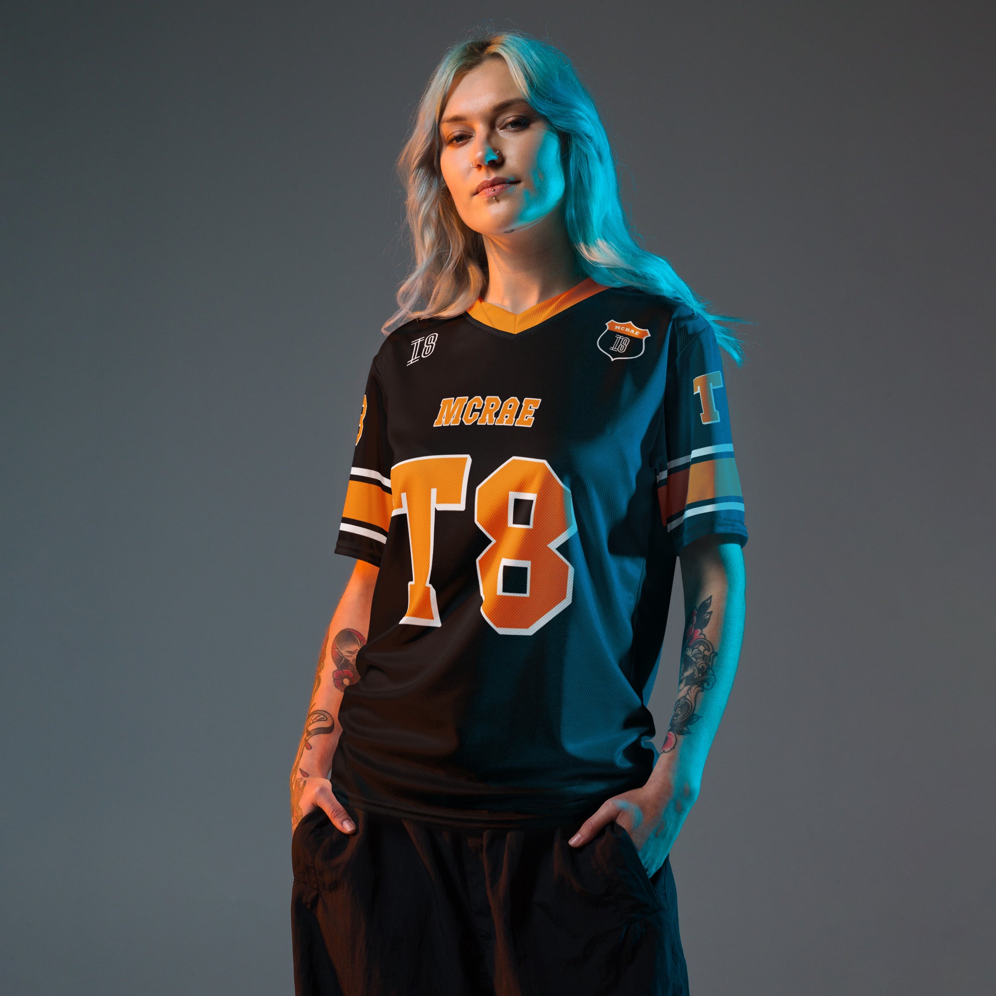 A orange, black. and white football jersey with Tate Mcare on the back and front in orange with a white outline.