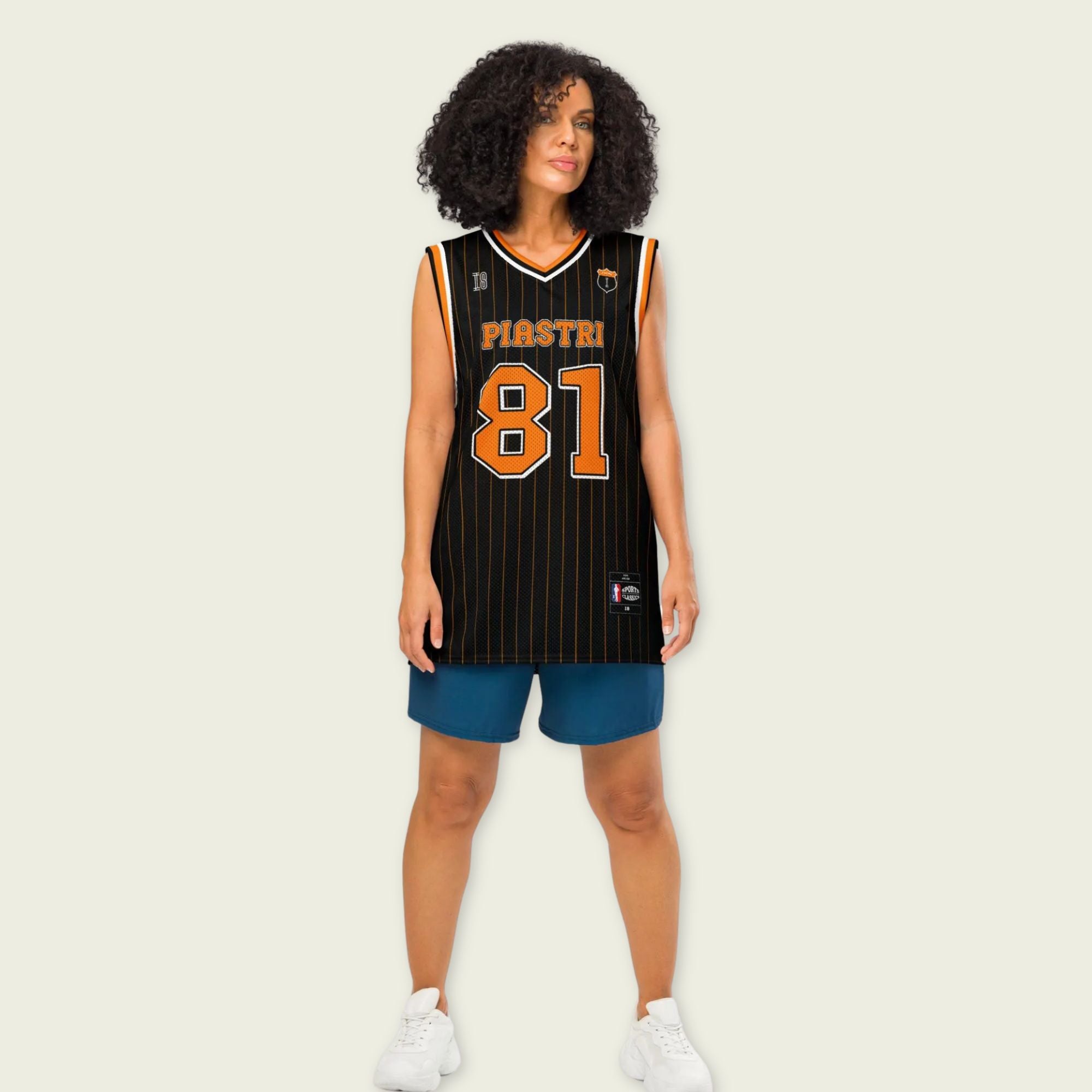 A black and papaya orange pin striped basketball Jersey with Oscar Piastri's McLaren F1 racing number 81 in orange on the front and back.