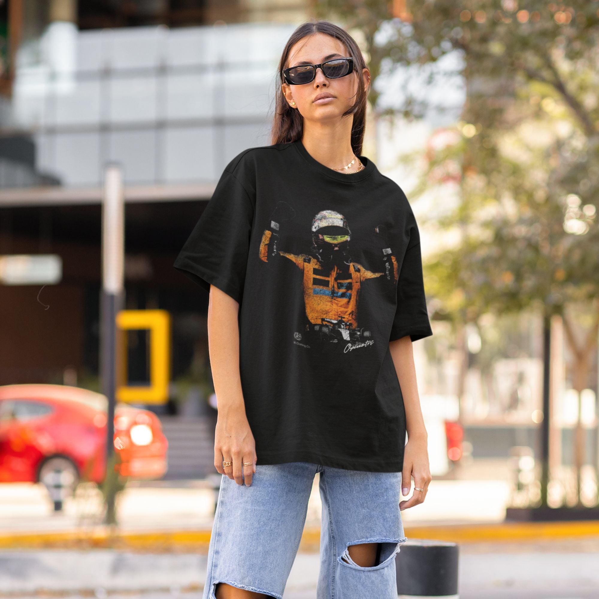 Woman wearing a black t-shirt with a graphic design outdoors