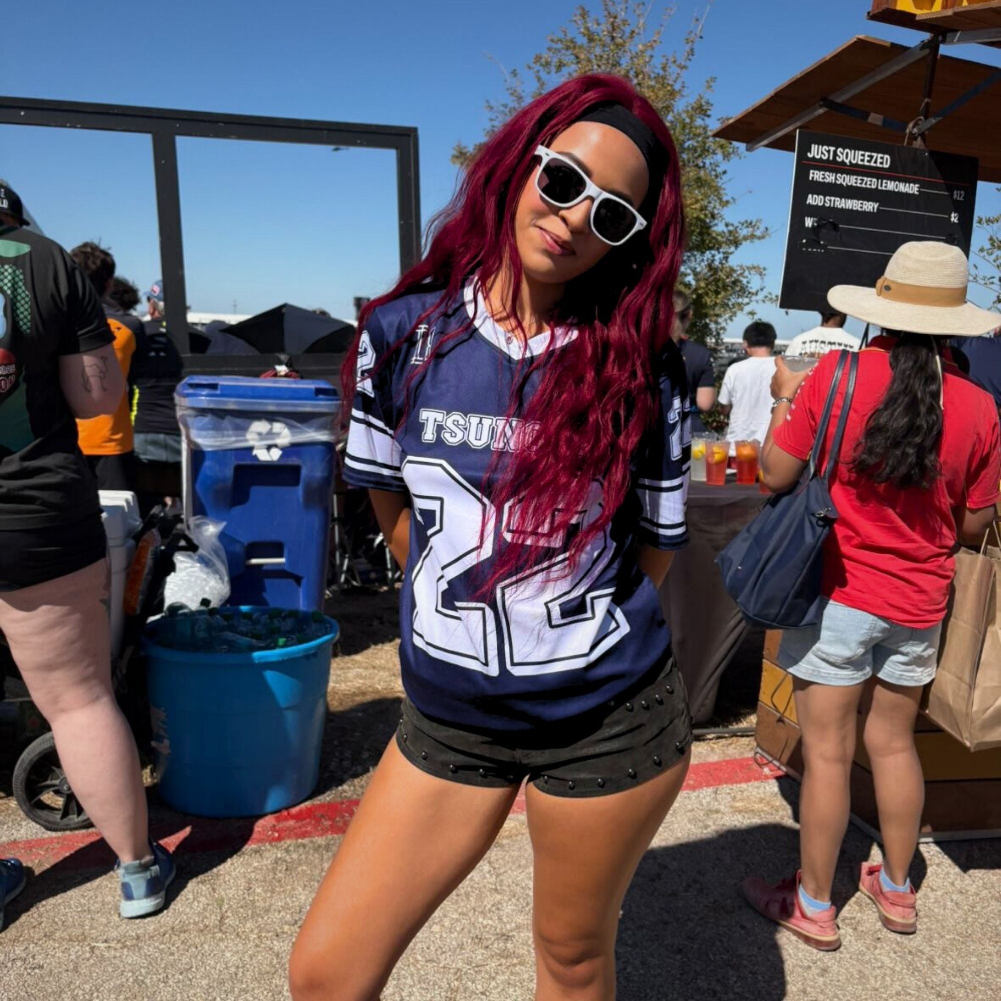 Person wearing a sports jersey with visible branding in an outdoor setting