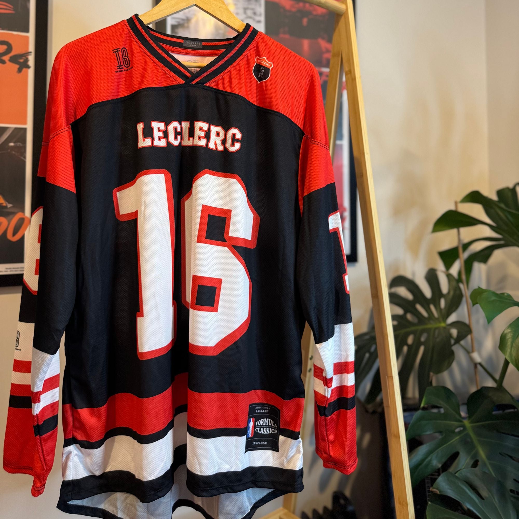 Hockey jersey with number 18 and name 'Leclerc' on a hanger