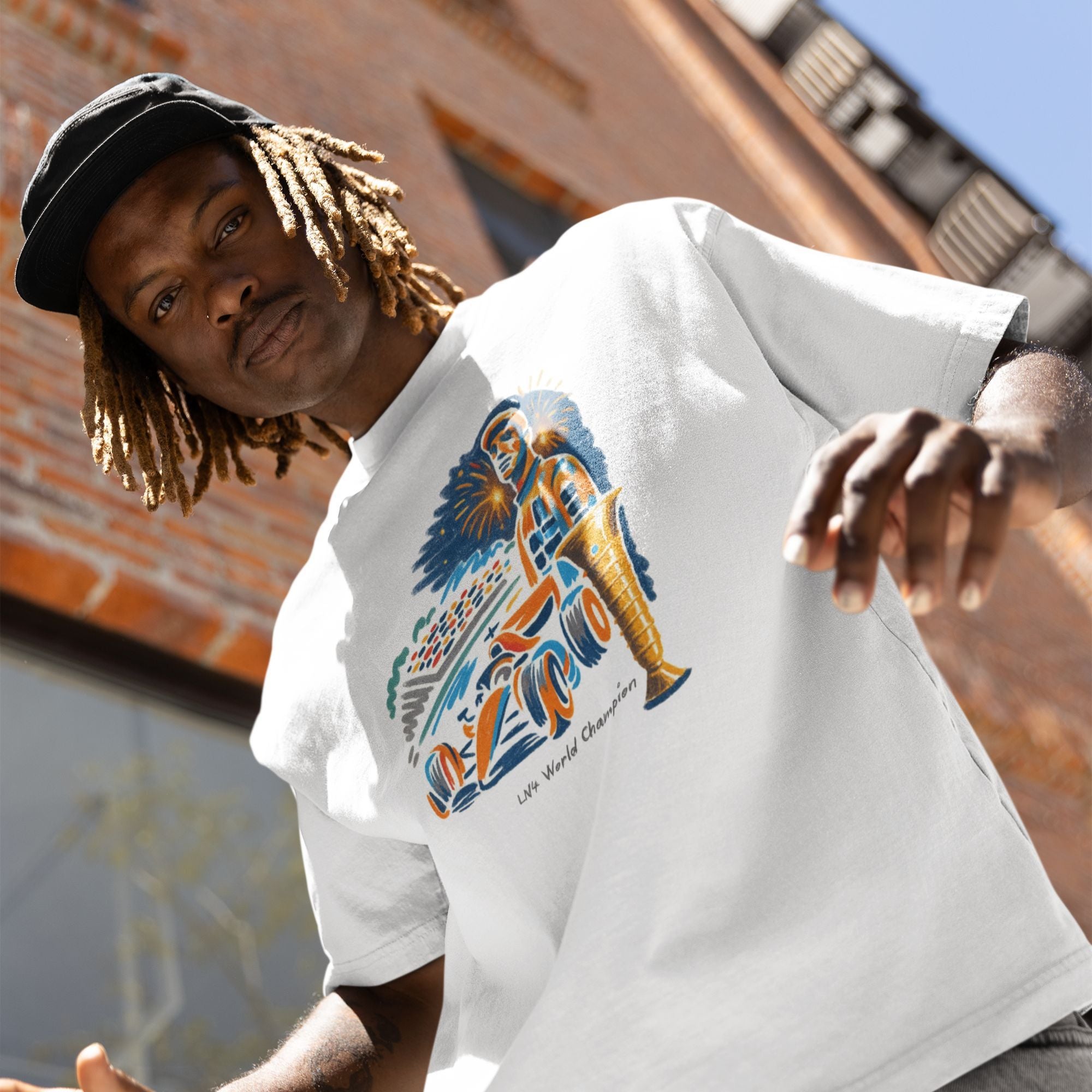 Person wearing a white t-shirt with a colorful graphic design, standing outdoors.