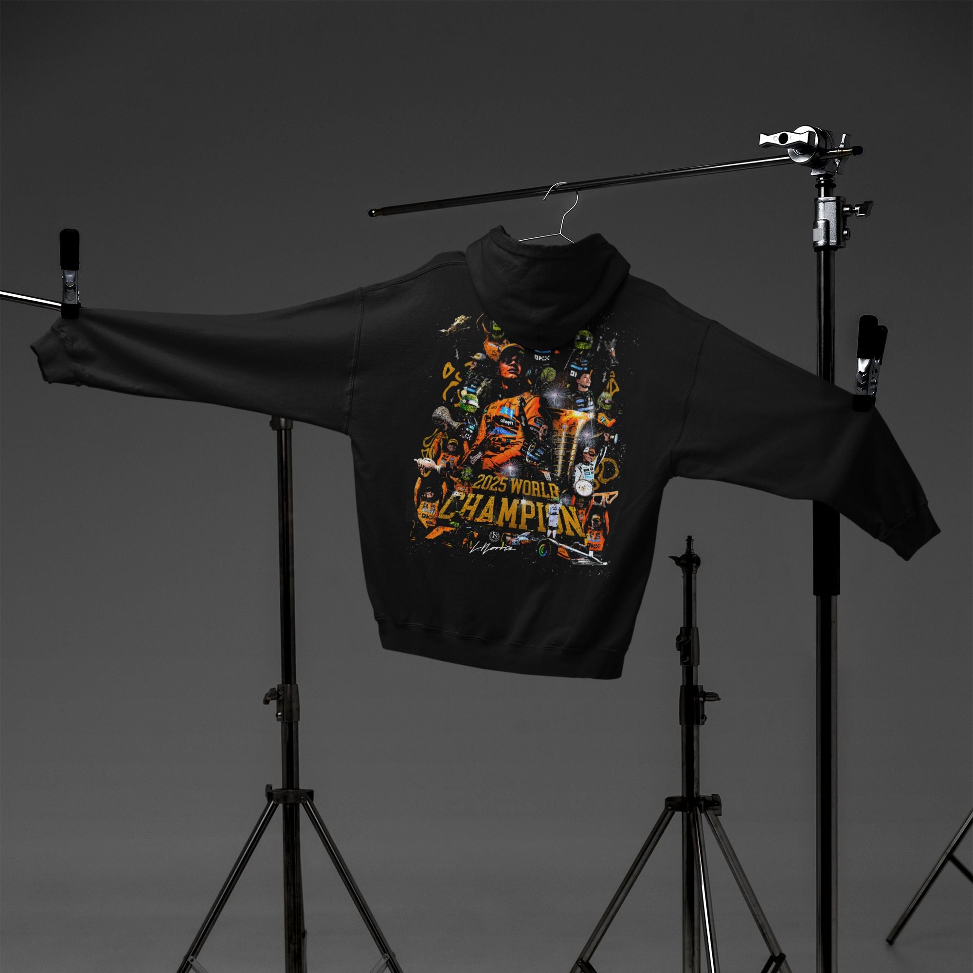 Black hoodie with colorful graphic design on a hanger against a dark background