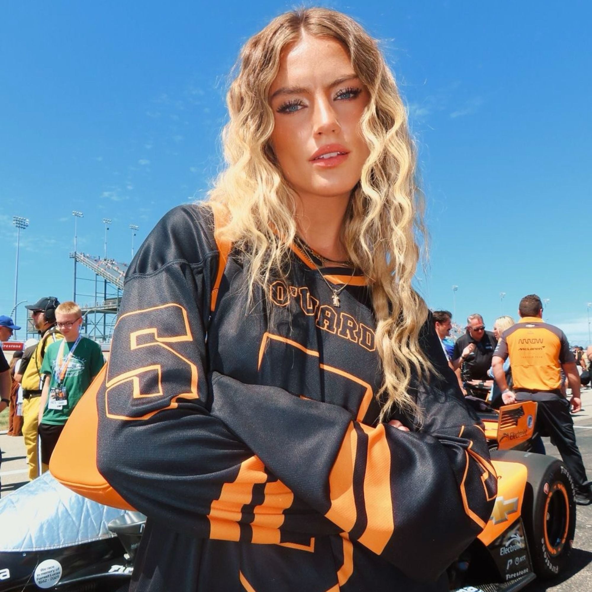 A black hockey jersey with Pato Owards name and indycar racing number 5 on the front and back in orange.