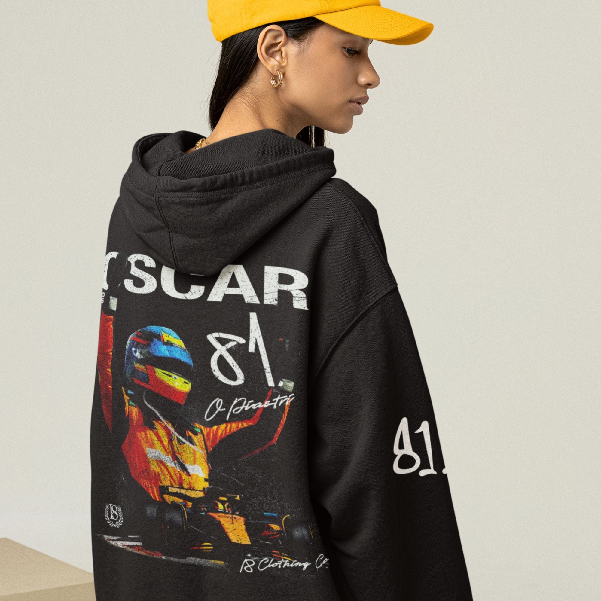 Person wearing a black hoodie with colorful graphics and text on the back, against a plain background.